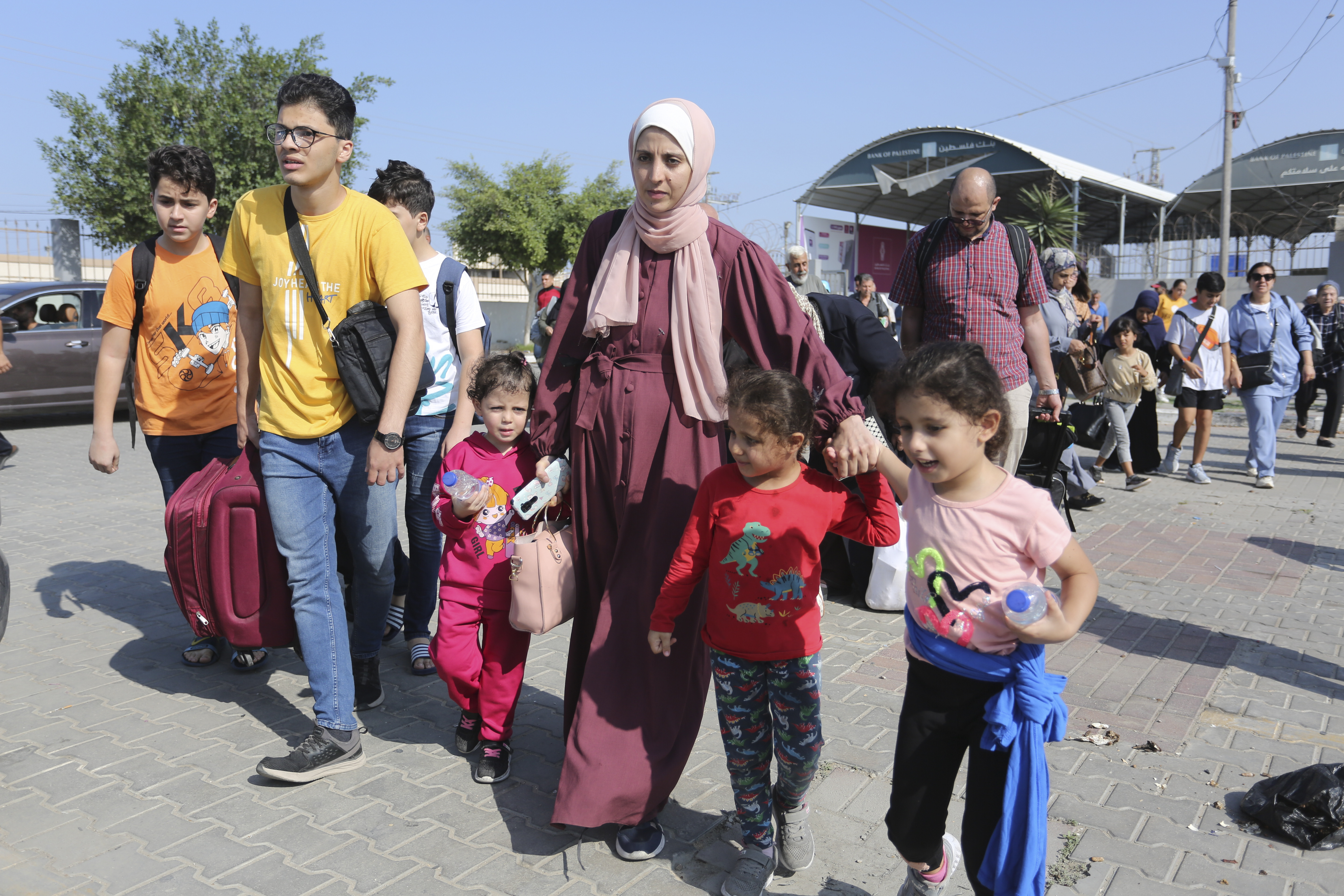 Palestinians cross to the Egyptian side of the border crossing with the Gaza Strip. Photo / AP