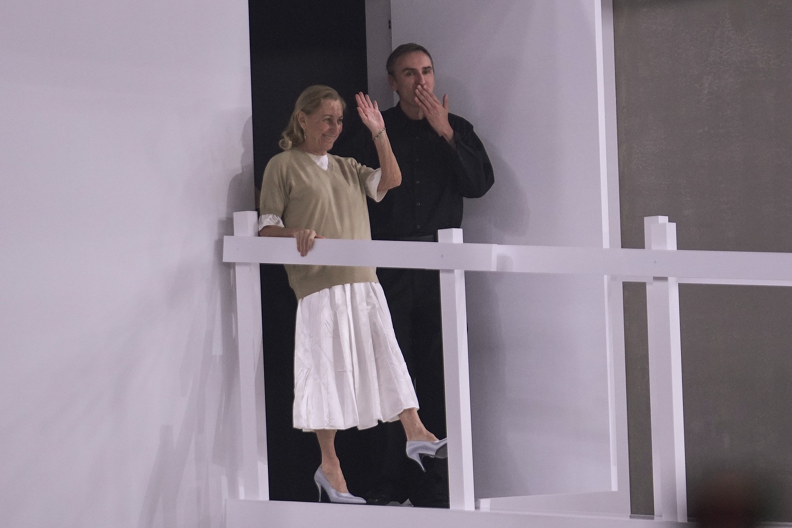 Head designers Miuccia Prada and Raf Simons after the show in Milan. Photo / AP