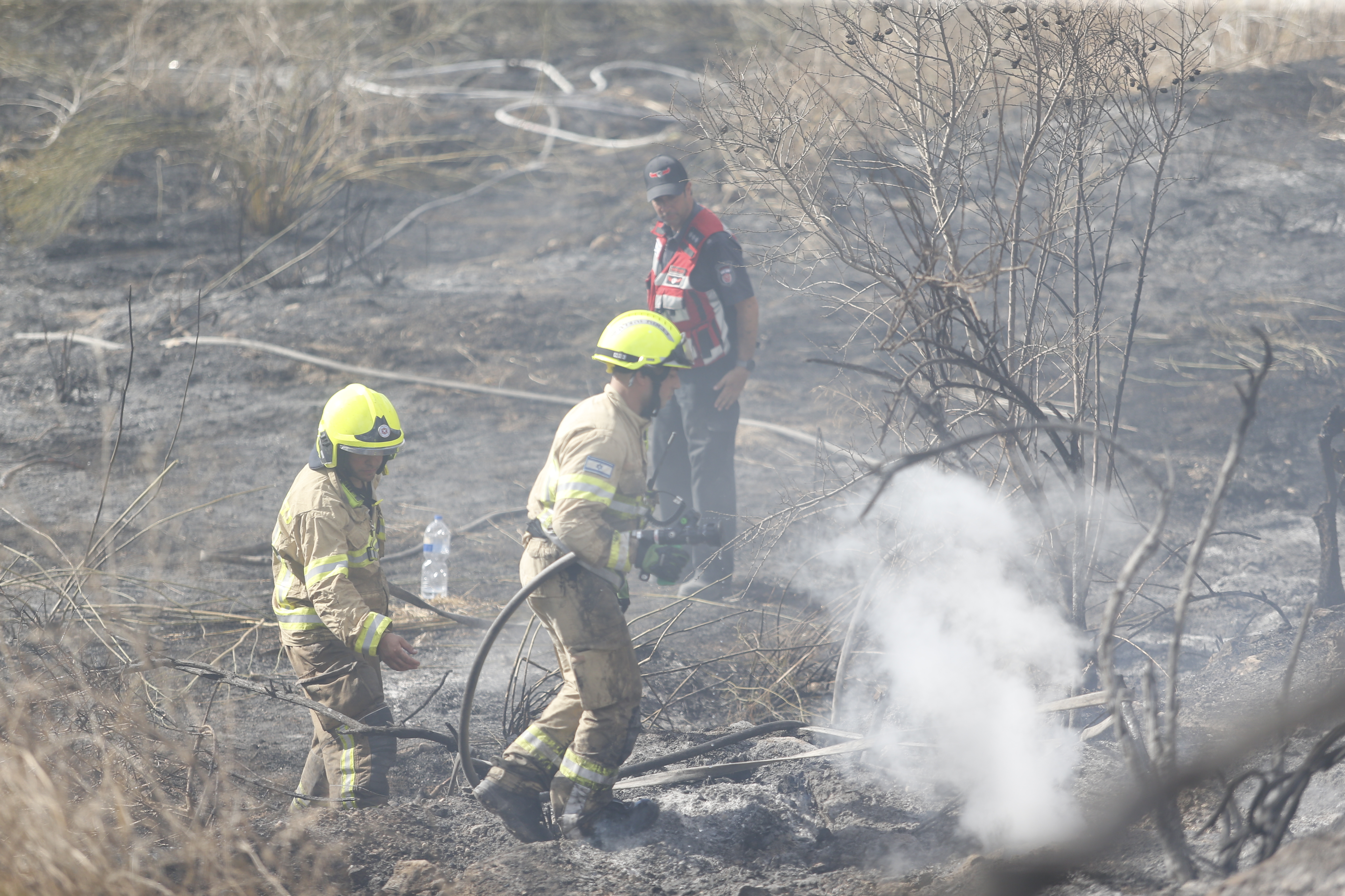 Firefighters try to extinguish the fires as nine Israelis were injured with minor wounds following the launch of a surface-to-surface missile from Yemen towards Lod, Israel, according to the Israeli army, on September 15. Photo / Getty Images
