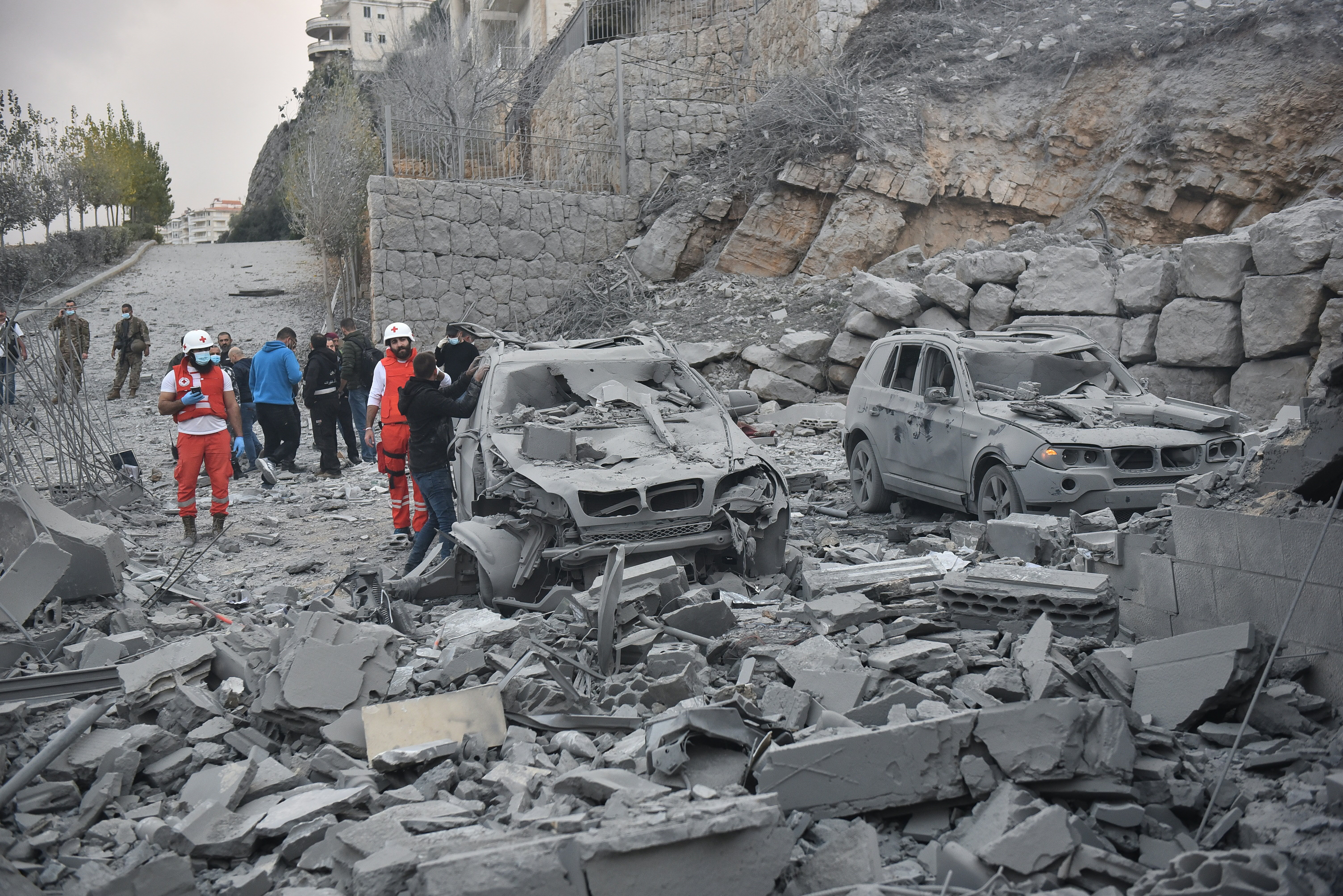 Rescue teams stand next to damaged cars at the site of an Israeli airstrike that targeted the village of Baalshmay in the Lebanese mountains, east of Beirut, on November 12, 2024. Photo / AFP