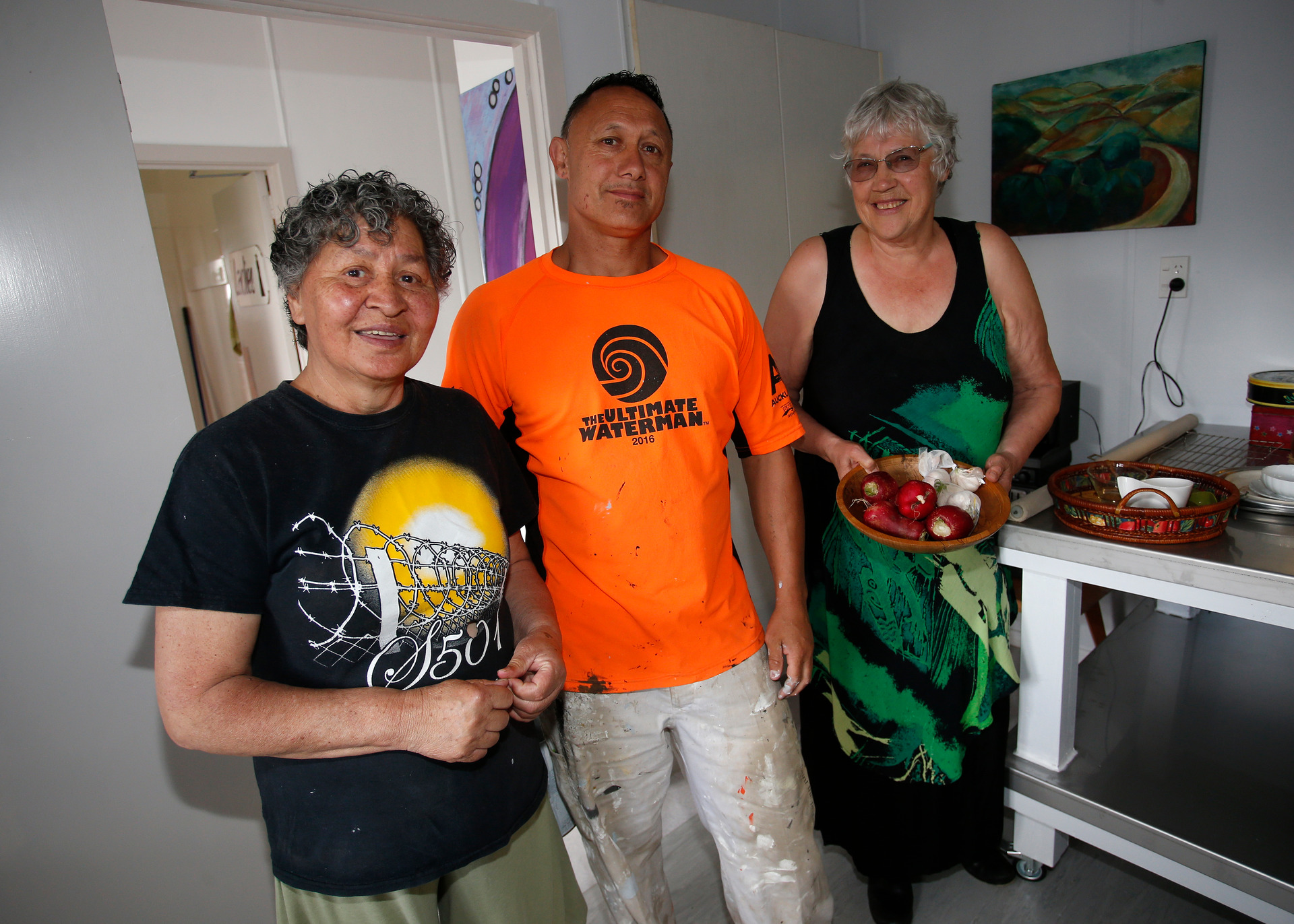 Carrie Kake, painter Craig Sullivan and Carol Peters in the kitchen of Open Arms. Photo/Michael Cunningham
