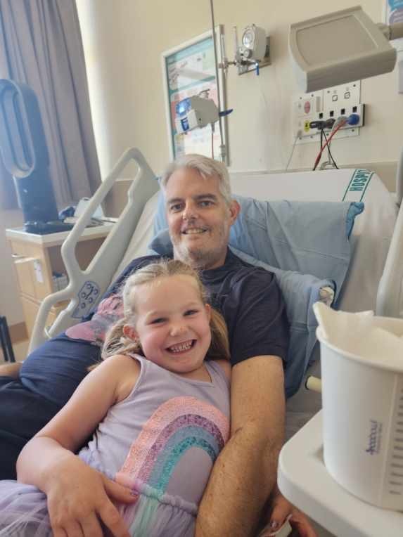 Simon Clark with his daughter Eleanor, 4, who visited him in North Shore Hospital.