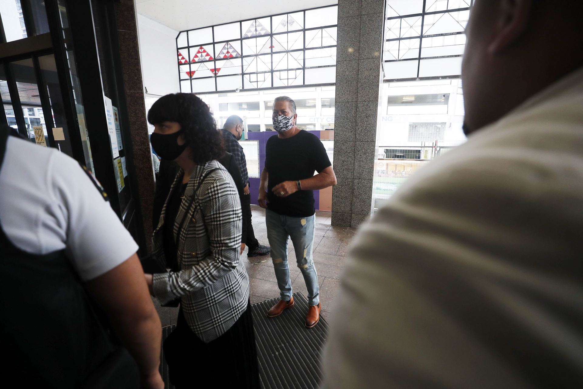 Destiny Church leader Brian Tamaki and church member Jennifer Louise Marshall enter Auckland District Court ahead of a case review hearing. Photo / Dean Purcell