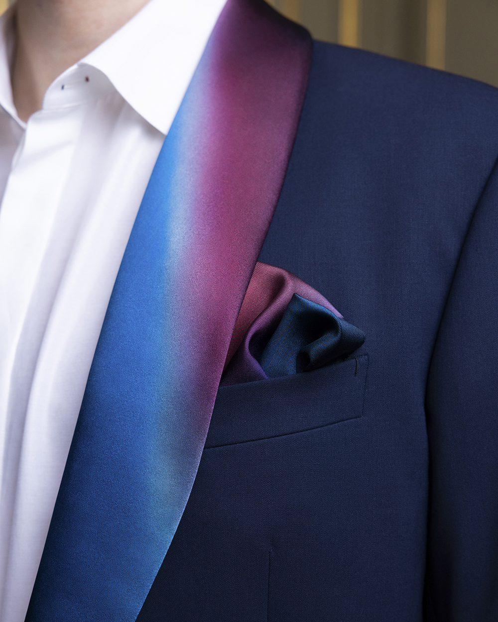 The collar lapels are a dégradé version of the French tricolour. A matching silk scarf can be tucked into a pocket. Photo / Marie-Laure Dutel via The New York Times