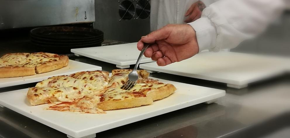 A stretch test of mozzarella cheese is made at Fonterra's Clandeboye site in South Canterbury. Photo / Chris Tobin
