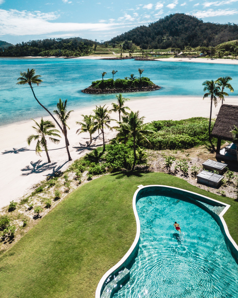 Lush trees and flowering bushes feature throughout the resort, making wandering the sandy paths barefoot (encouraged) an idyllic experience. Photo / Supplied