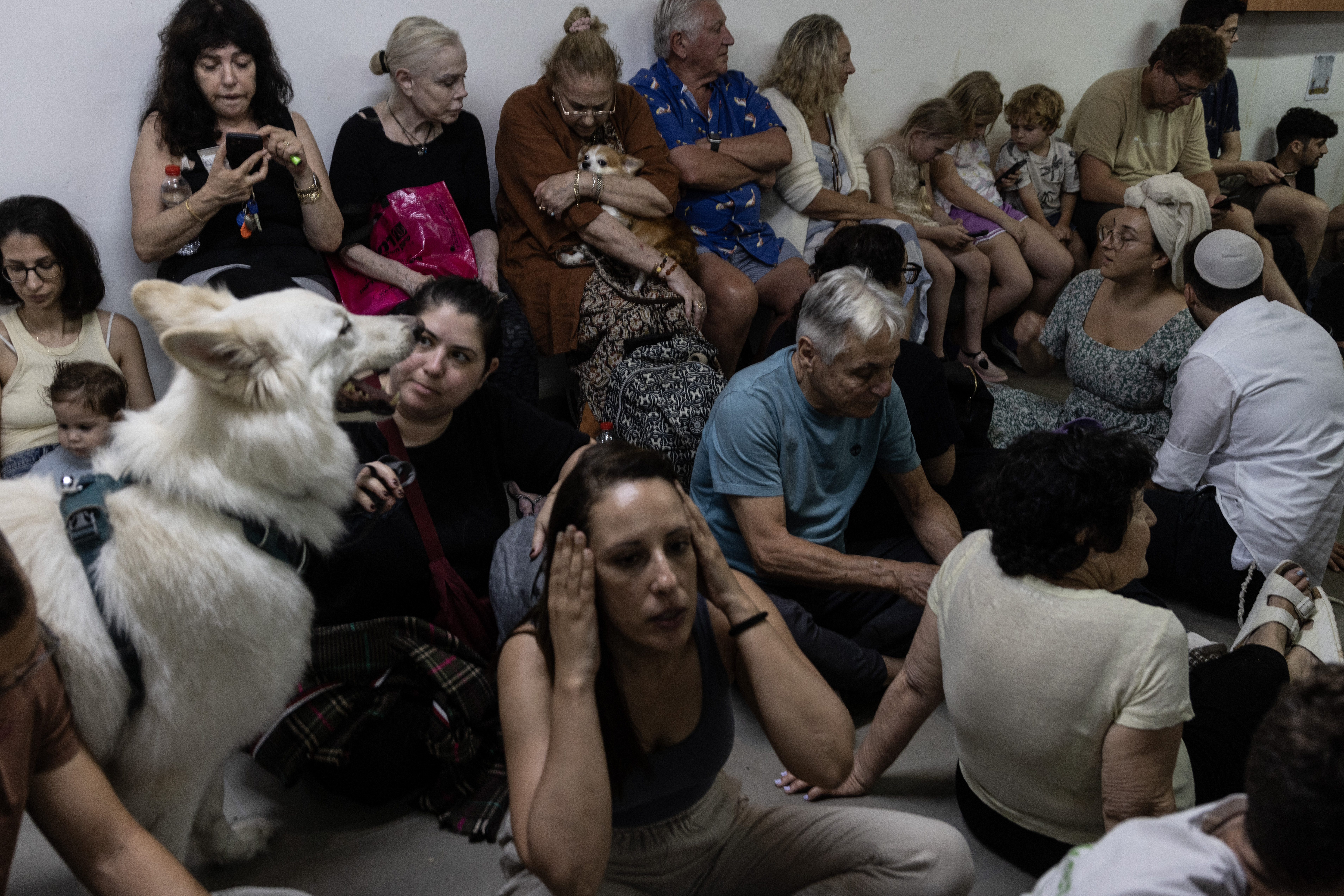 People huddle in an underground public shelter last Friday in Tel Aviv during a retaliatory attack by Iran after Israel launched airstrikes on its neighbour. Photo / the Washington Post