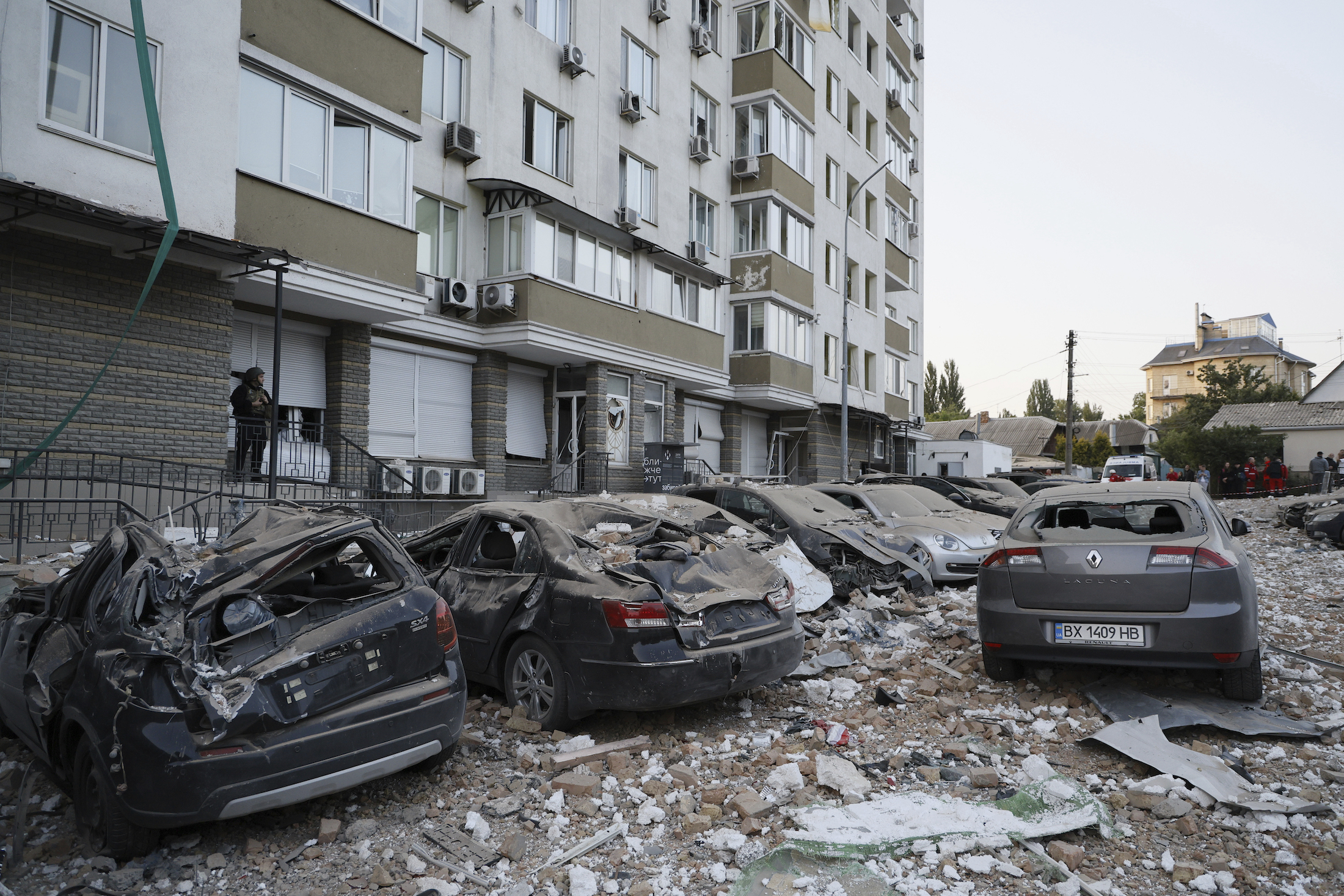 Damaged cars are parked in the yard of a multi-storey apartment building which was damaged in a relentless wave of bombardments targeting in Kyiv, Ukraine this week. Photo / AP