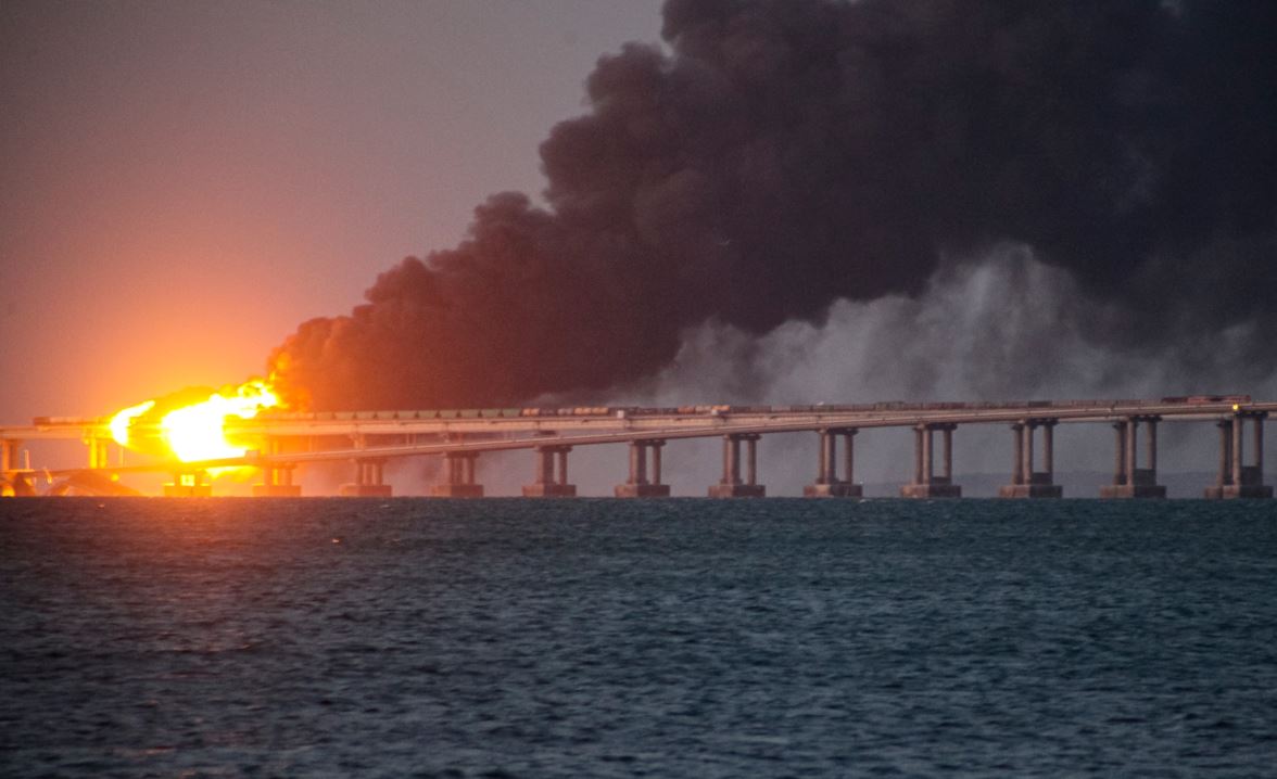 Flame and smoke rise from the Crimean Bridge connecting Russian mainland and the Crimean peninsula over the Kerch Strait. Photo / AP