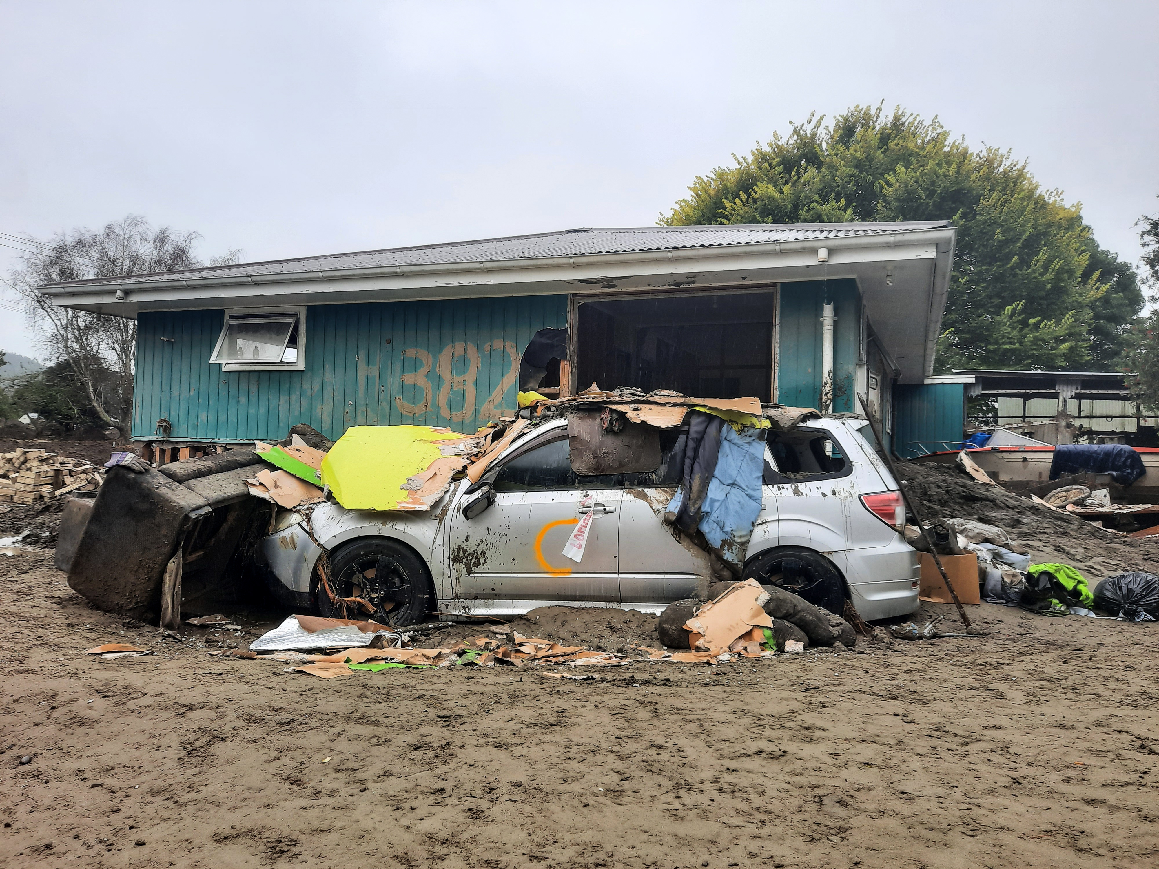 A car sits abandoned amid debris in flood-ravaged Esk Valley on February 23, 2023. Photo / Neil Reid