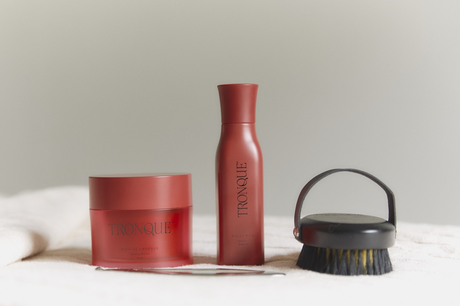 Tronque Rich As Croesus Firming Butter, Body Contour Massager, Fully Ripe Vitamin C Body Oil and Ionic Dry Body Brush. Photo / Supplied