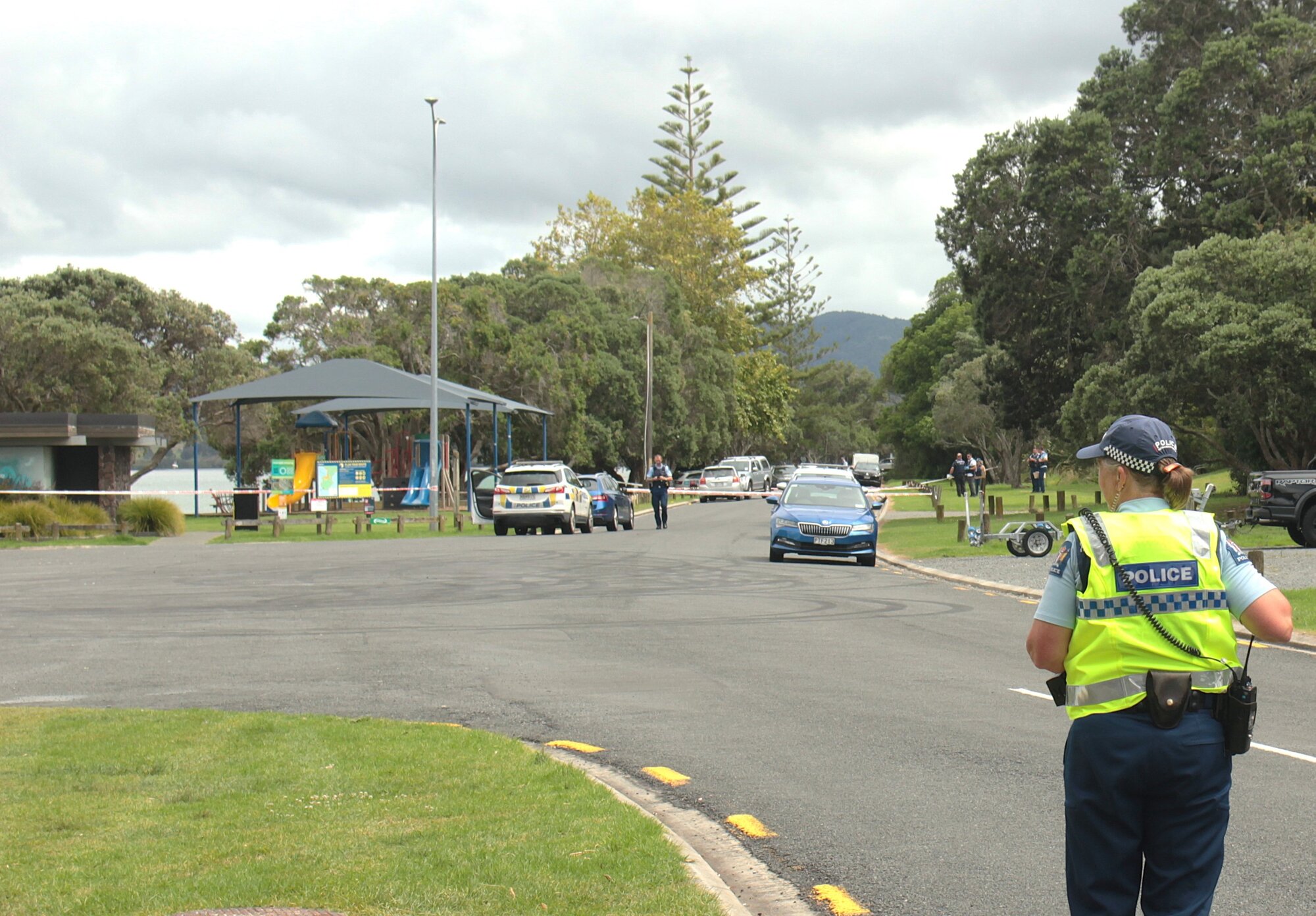 Police investigate the heavily guarded homicide scene on Beach Rd in Onerahi, Whangārei - a park popular with fishers, dog walkers and freedom campers. Photo / Denise Piper