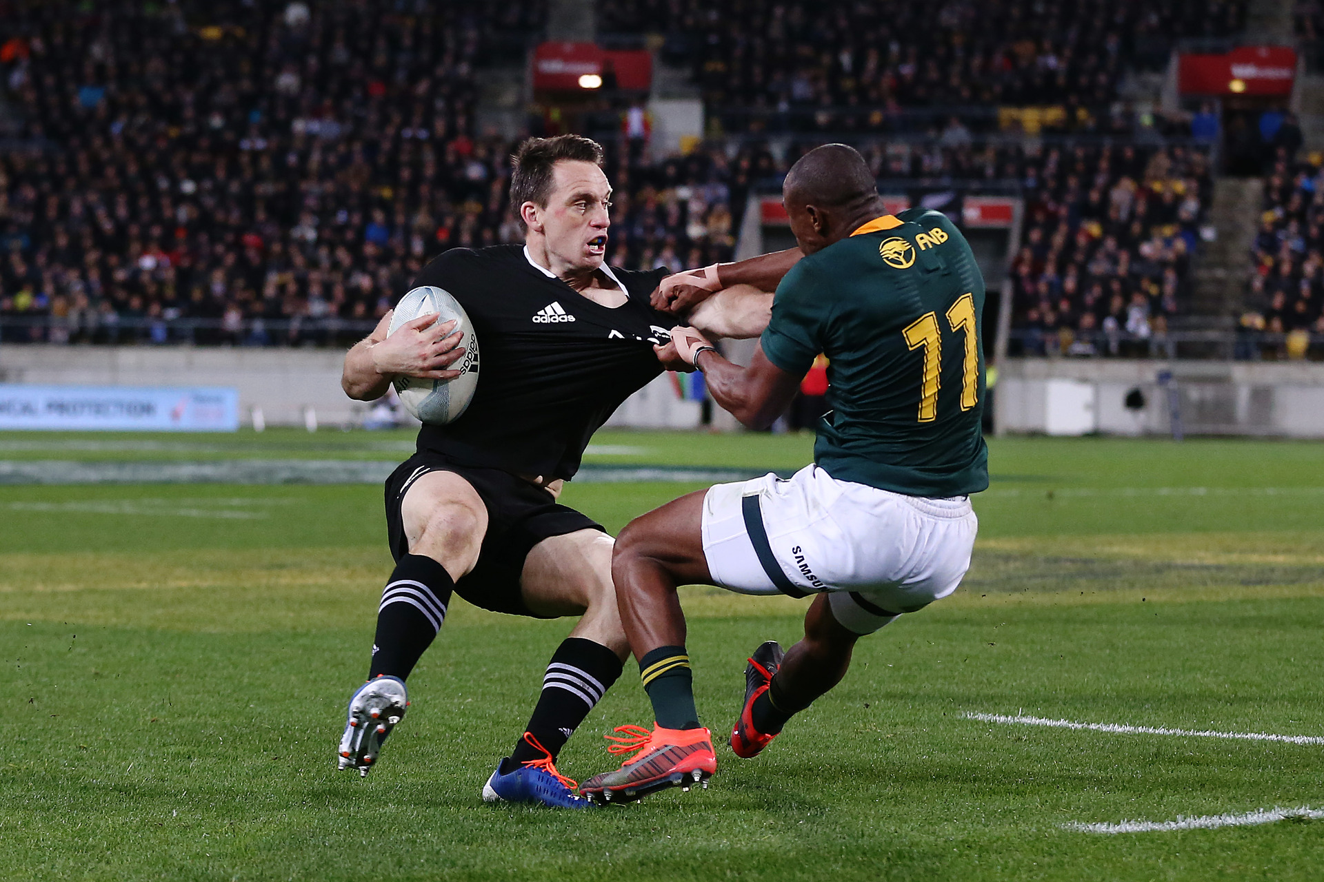 Ben Smith tries to fend off South African winger Makazole Mapimpi. Photo / Getty Images 