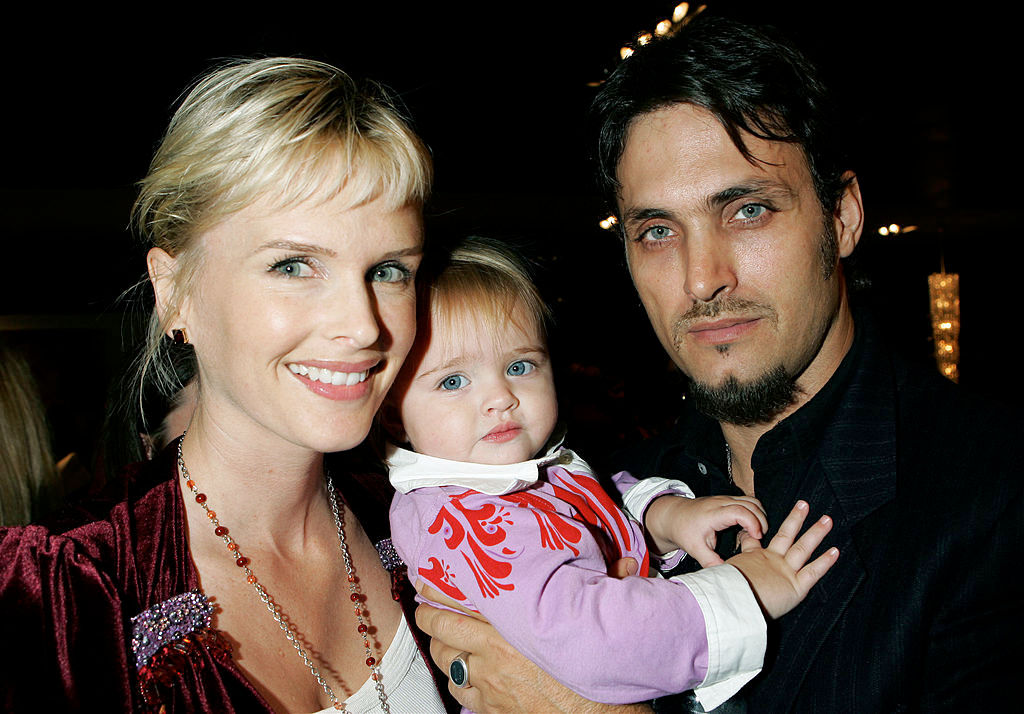 Kylie Bax poses with her husband Spiros Poros and their daughter Lito in 2005. Photo / Getty Images