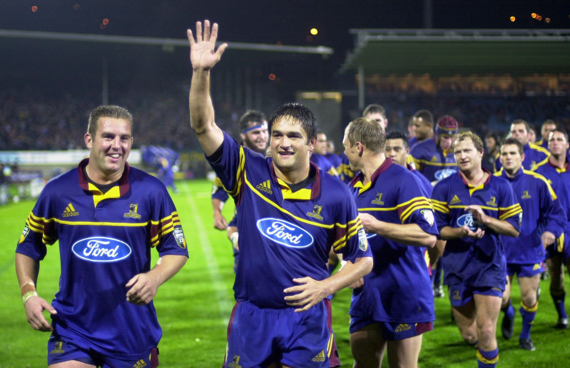 Highlanders captain Taine Randell (2nd from left) is all smiles , as he runs with fullback Brendan Laney (L) on a lap of honour, after his team defeated the Crusaders. Photo / Getty Images.