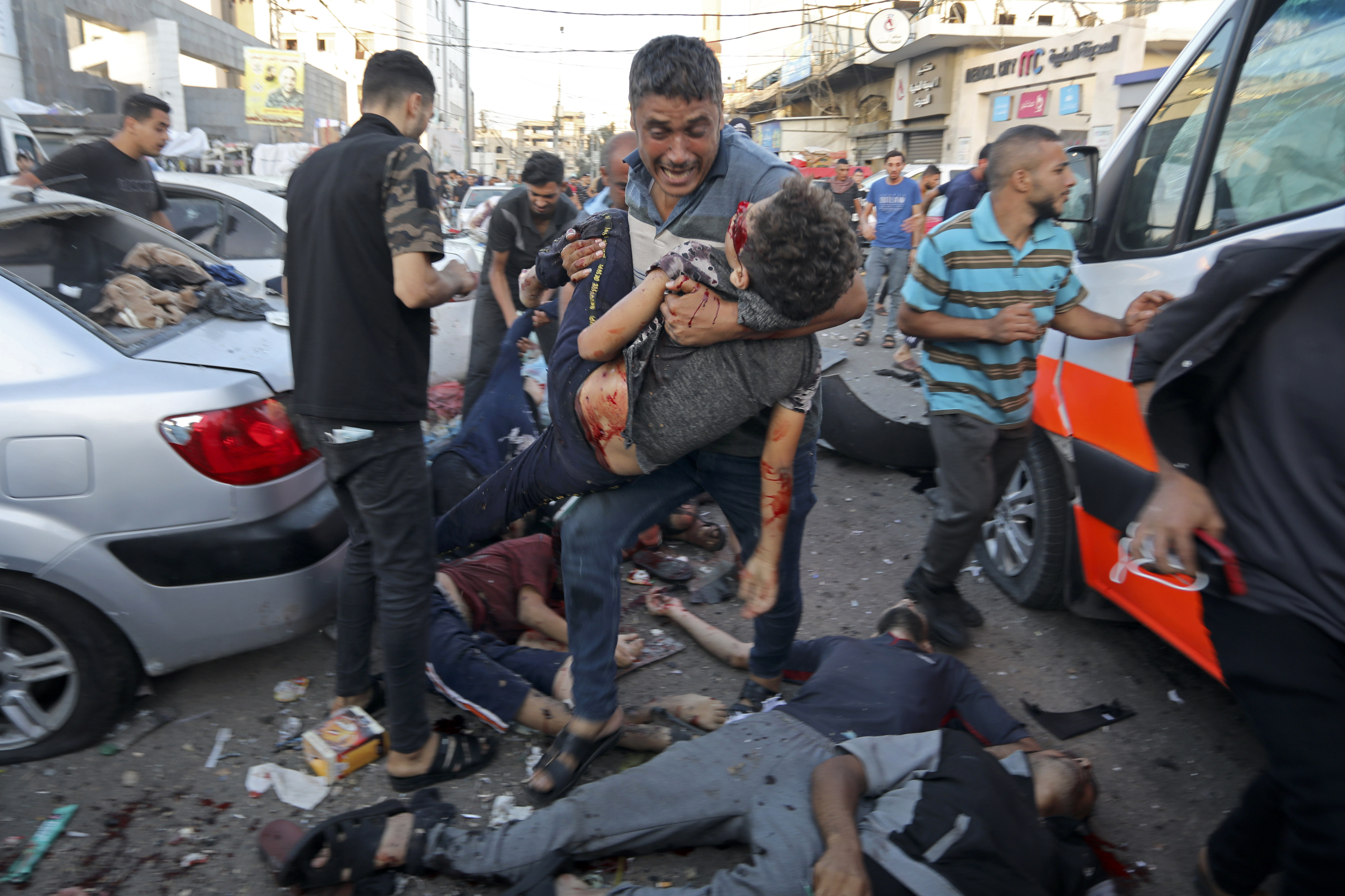 A man steps over the bodies of dead and injured Palestinians lying on the ground following an Israeli airstrike outside the entrance of the al-Shifa hospital in Gaza City. Photo / AP