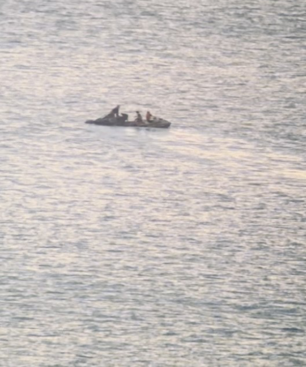 Two surfers on jetskis raced out to the skydiver first. Photo / Supplied