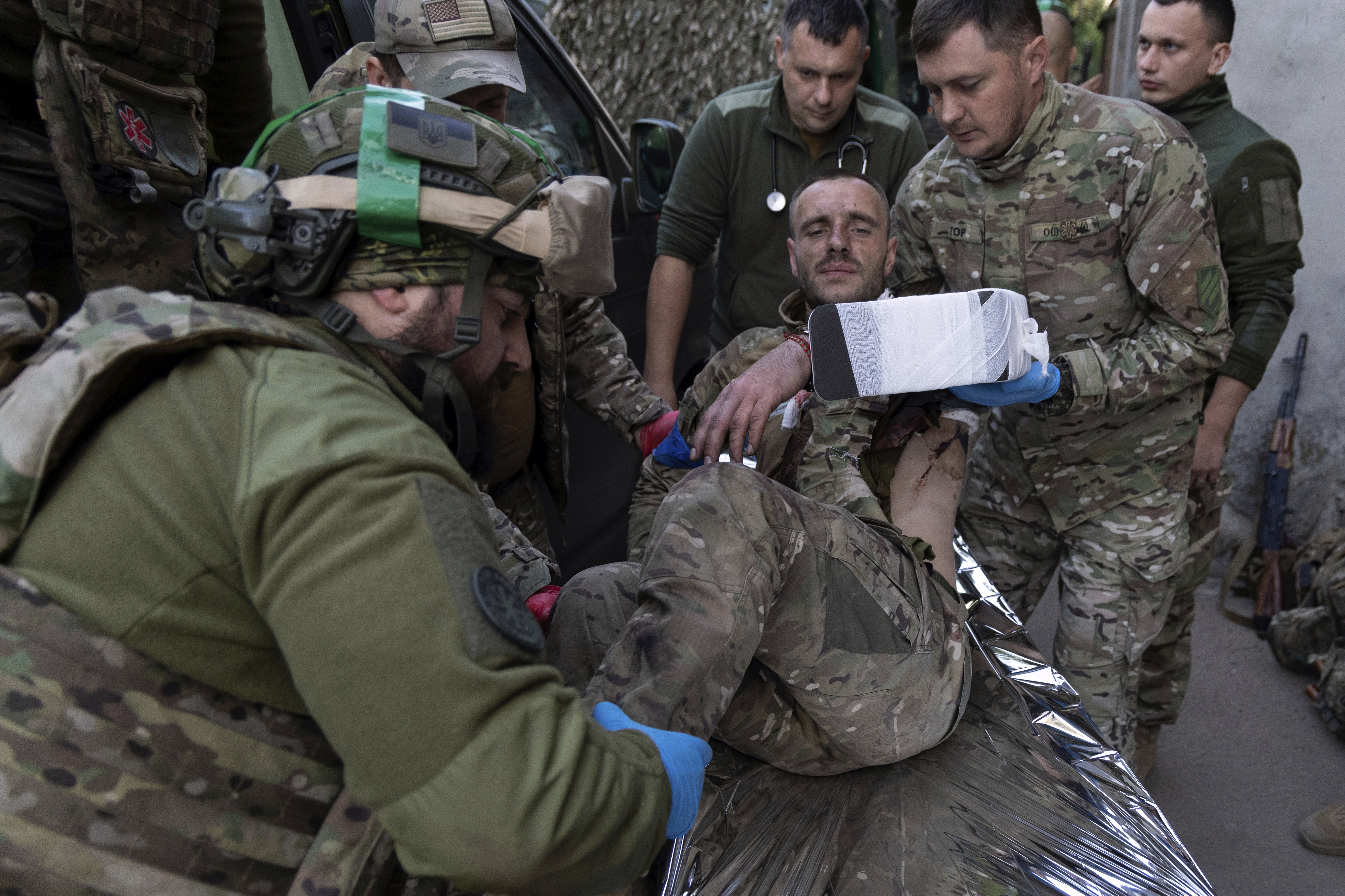 Ukrainian paramedics from the third assault brigade move their wounded comrade on a stretcher arriving from the battlefield to the field hospital near Bakhmut, Donetsk region, Ukraine. Photo / AP