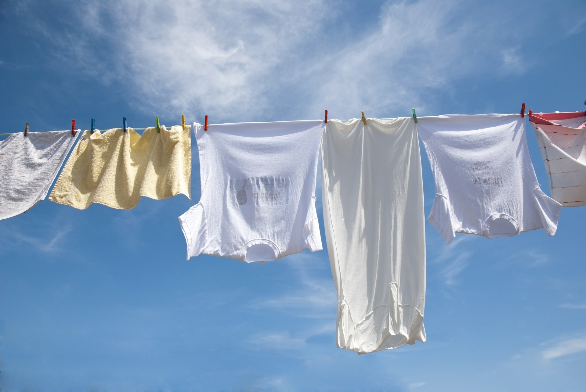 A woman hanging out her clothes on a clothes line photo – Cleaning day  Image on Unsplash