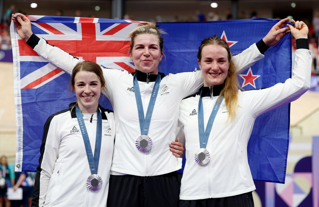 Silver medallists Rebecca Petch, Shaane Fulton and Ellesse Andrews of Team New Zealand pose on the podium holding the flag during the Women’s Team Sprint medal. Photo / Getty Images