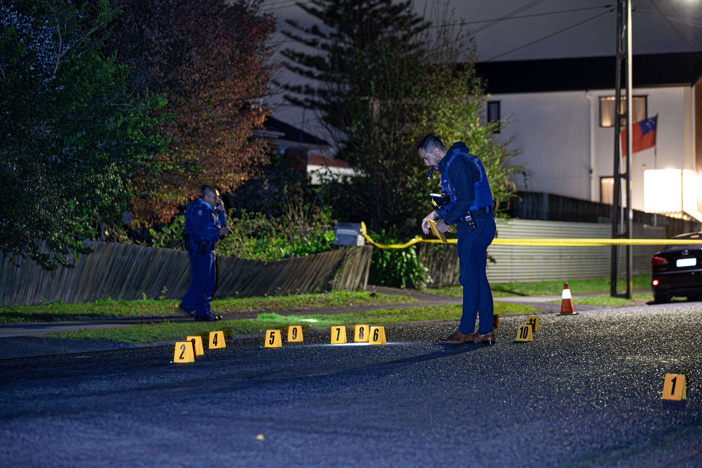 Police placed markers on the road where bullet casings were found on Haddon St. Photo / Hayden Woodward