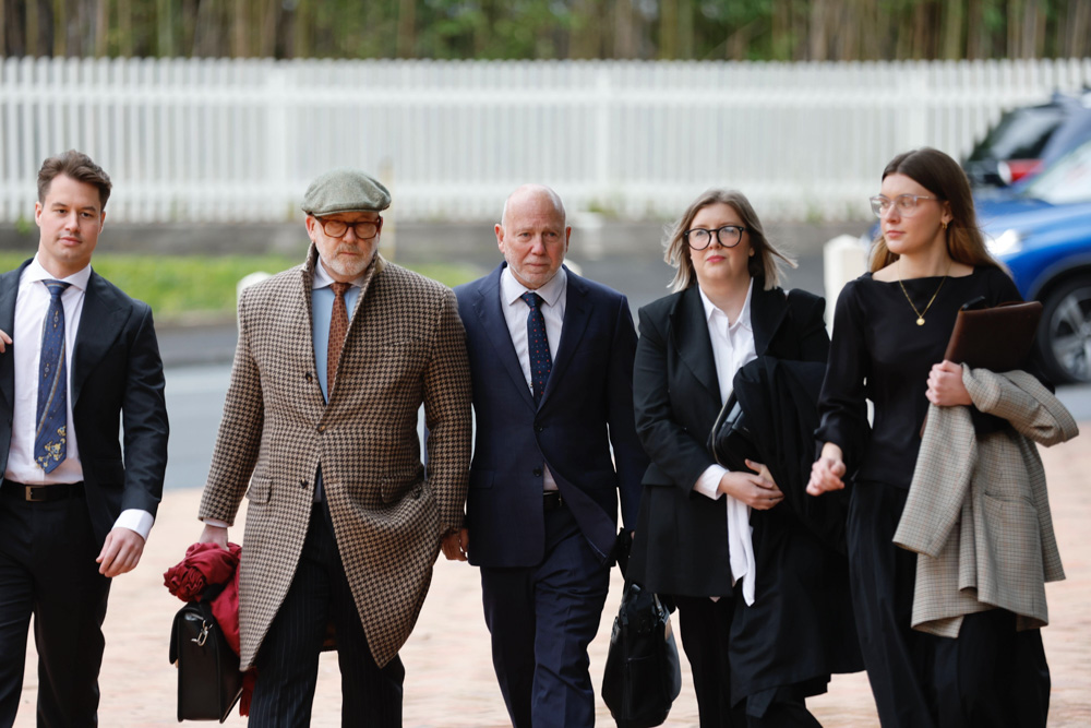 Phillip Polkinghorne (centre) arrives at Auckland High Court with his legal team, including Ron Mansfield, KC, left. Photo / Michael Craig