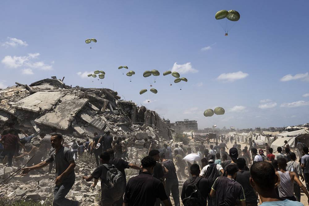 Planes drop aid packages by parachute over western Gaza City, Gaza. Photo / Anadolu via Getty Images