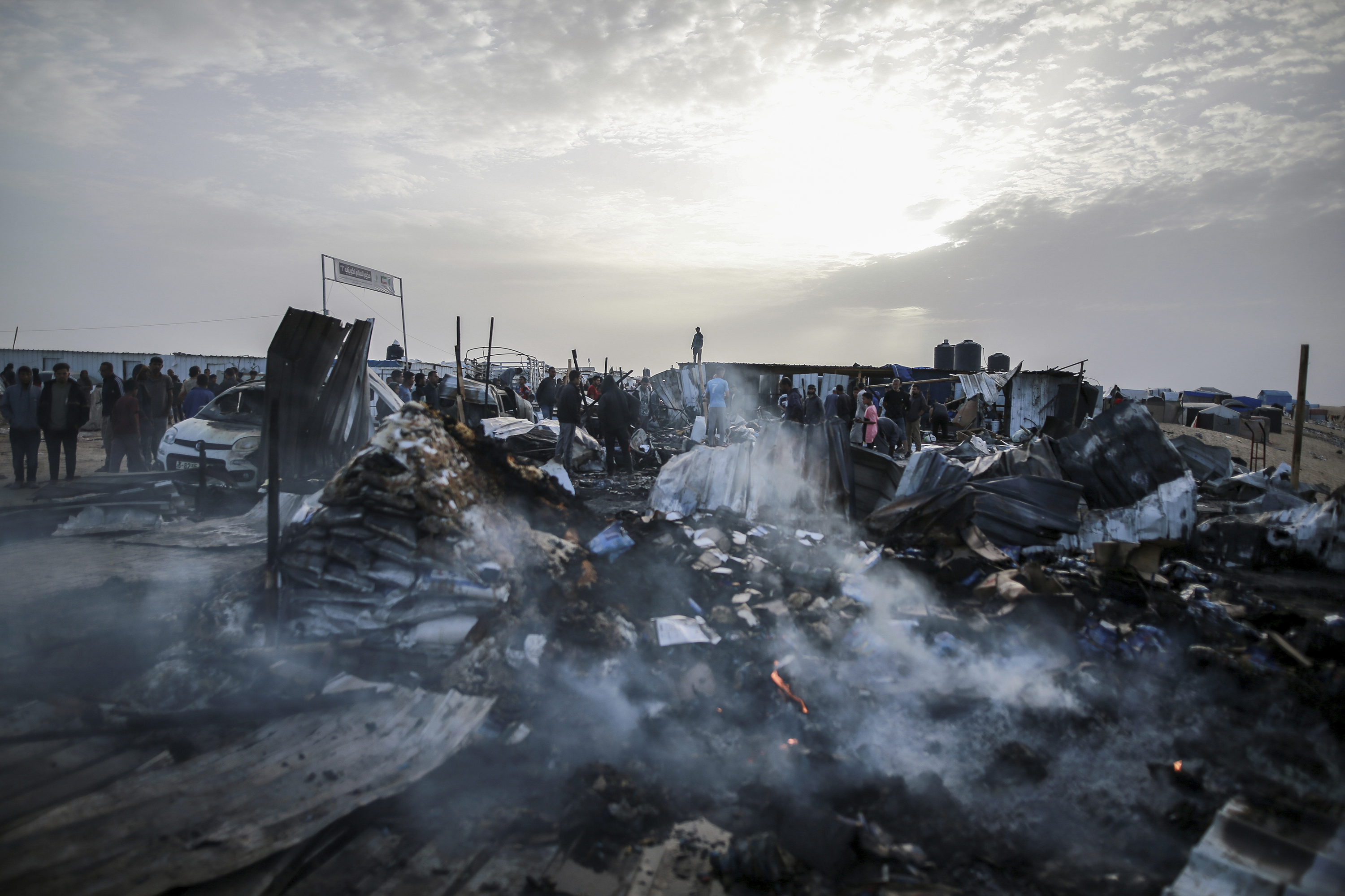 A photo from earlier this week shows Palestinians looking at the destruction after an Israeli strike where displaced people were staying in Rafah, Gaza Strip. Photo / AP