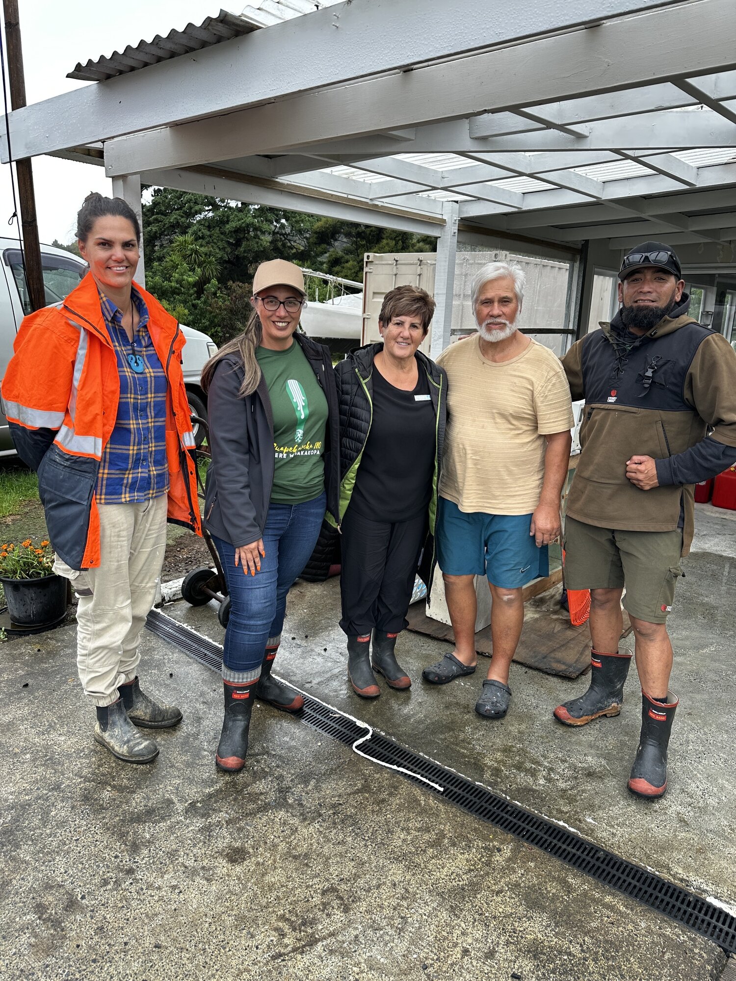 Ngaiotonga kaumātua Mane Kiwikiwi (second from right) enjoyed a visit from (from left) Ngaiotonga-raised Nicki Wakefield, Green MP Hūhana Lyndon, Acting Far North Mayor Chicky Rudkin and volunteer Ngawaru Munroe. Lyndon was visiting flood-affected community members on Tuesday and delivering kai from Ngātiwai including break, milk, fruit and water and checking on welfare.