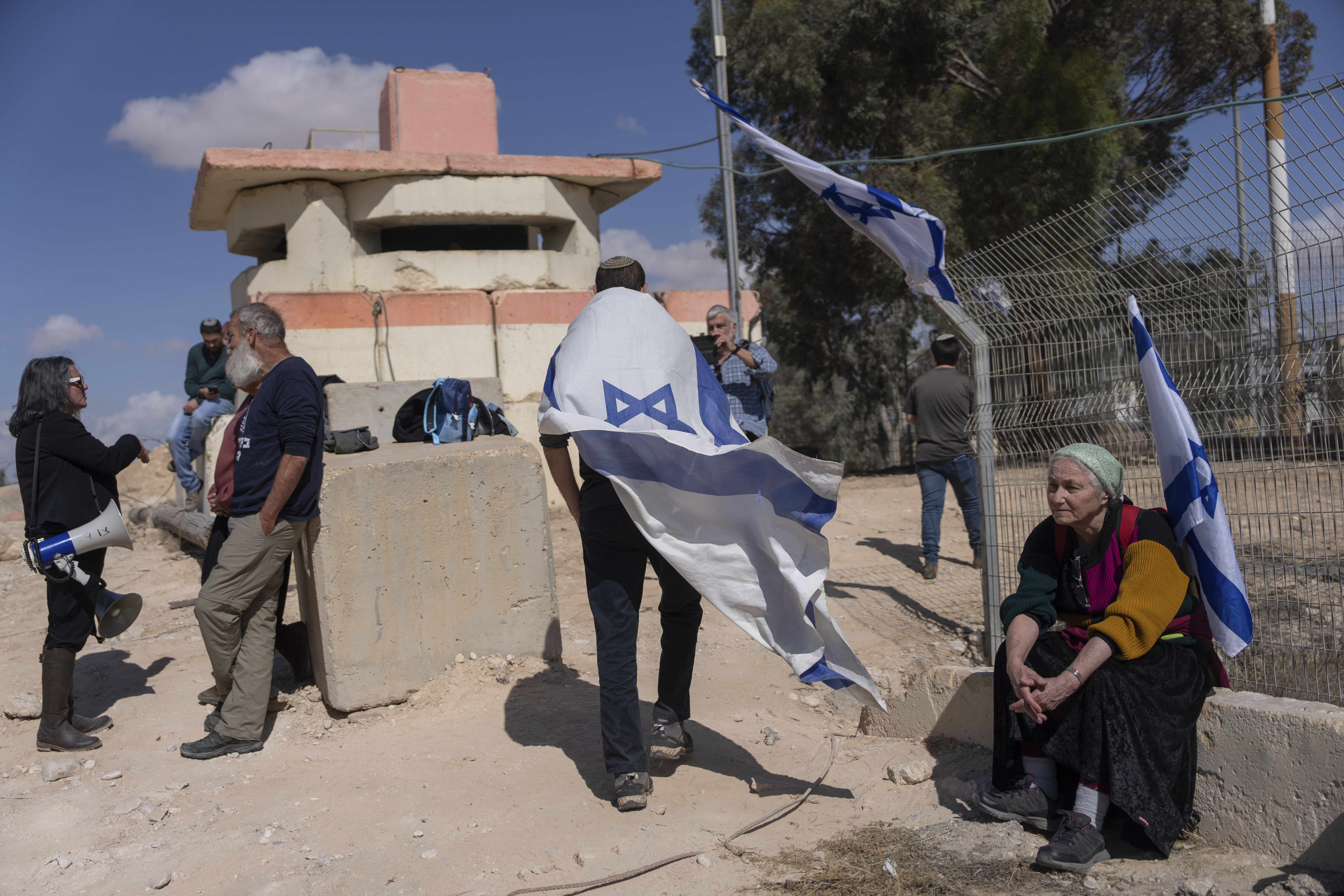 People stand in front of a gate at the Nitzana border crossing with Egypt, in southern Israel. Photo / AP