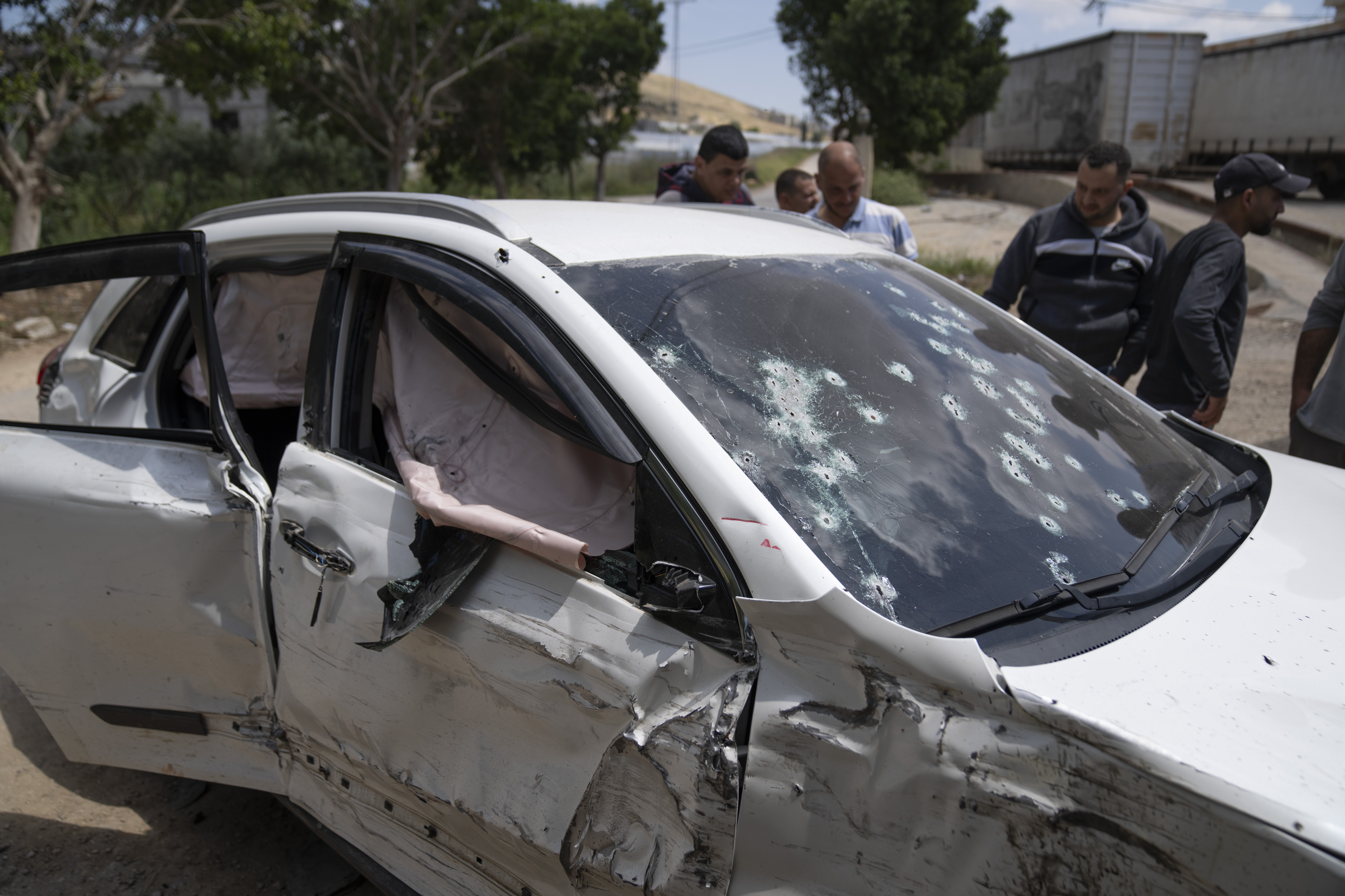 Palestinians inspect the shattered vehicle of Mohammad Daraghmeh, 26, a local Hamas commander who was killed in a shootout with Israeli soldiers early morning during an army raid, in the West Bank village of Tamoun, Friday, April 12, 2024. Two Palestinians were killed early Friday in confrontations with Israeli forces in the Israeli-occupied West Bank, Palestinian medics and the Israeli military said. The Islamic militant group Hamas said one of those killed was a local commander. (Photo/Nasser Nasser)