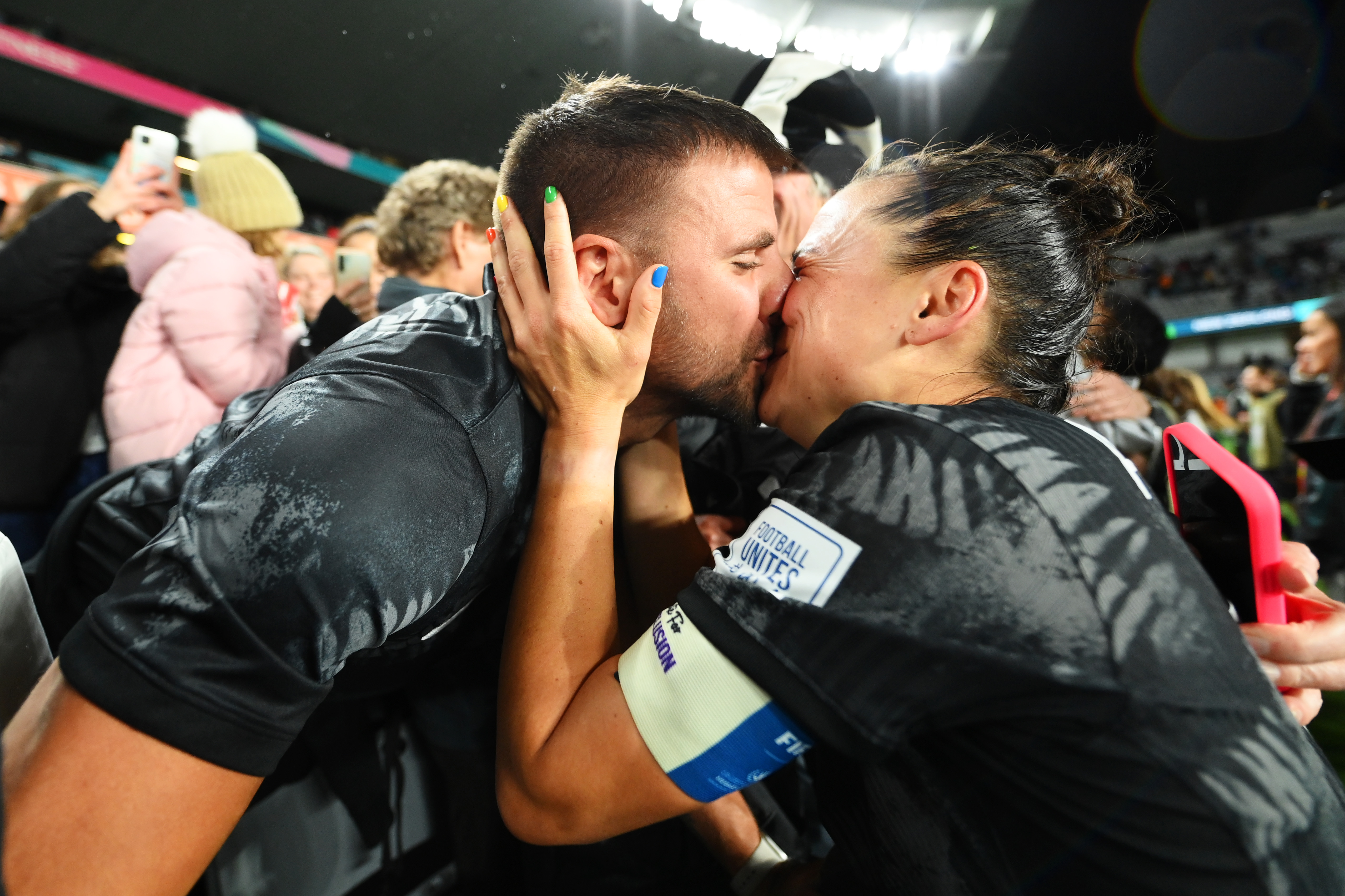 Ali Riley, New Zealand captain, paints nails in the colors of the Progress Pride  Flag