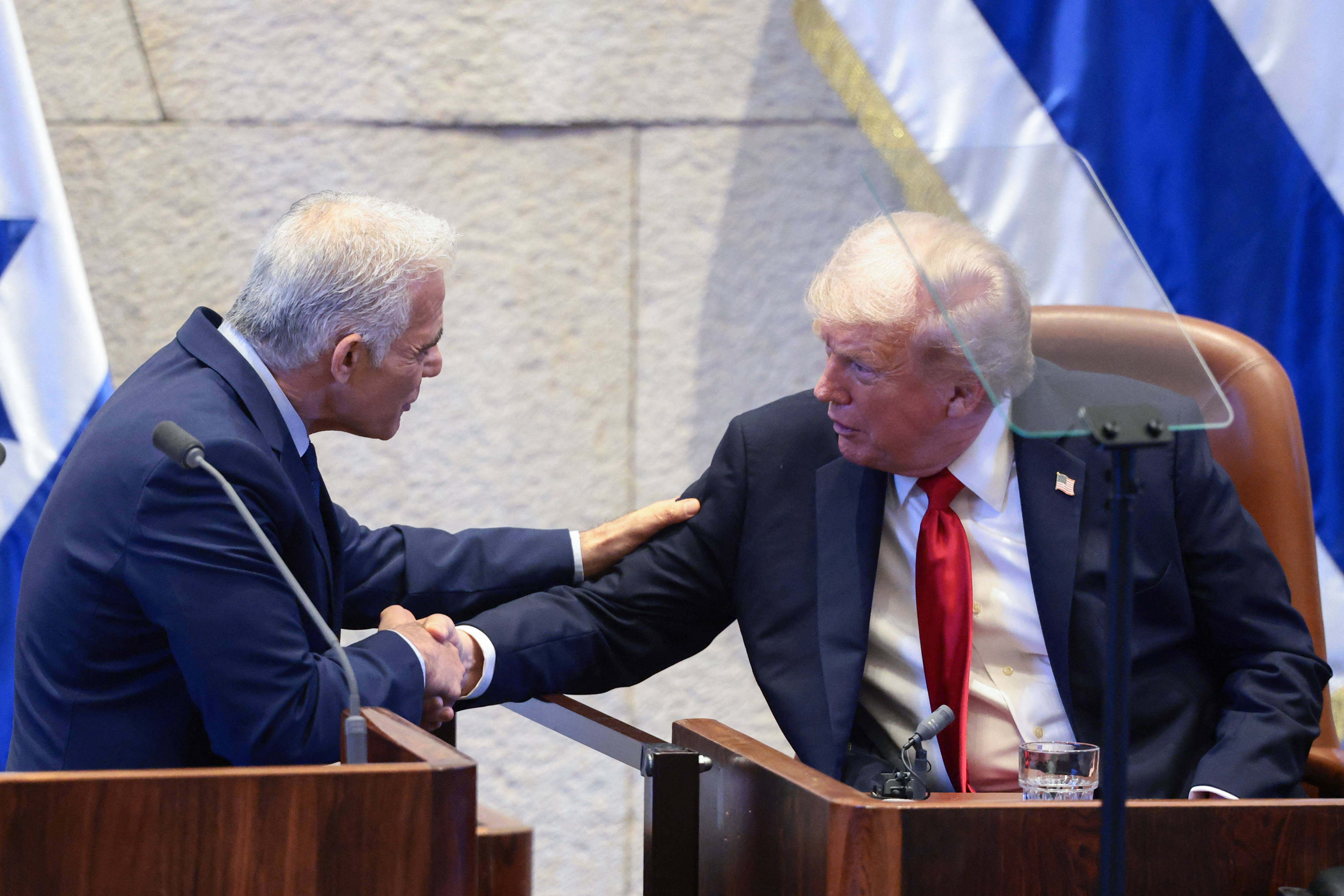 US President Donald Trump shakes hands with Israeli opposition leader Yair Lapid at the Israeli parliament, the Knesset, in Jerusalem. Photo / Evelyn Hockstein, POOL, AFP