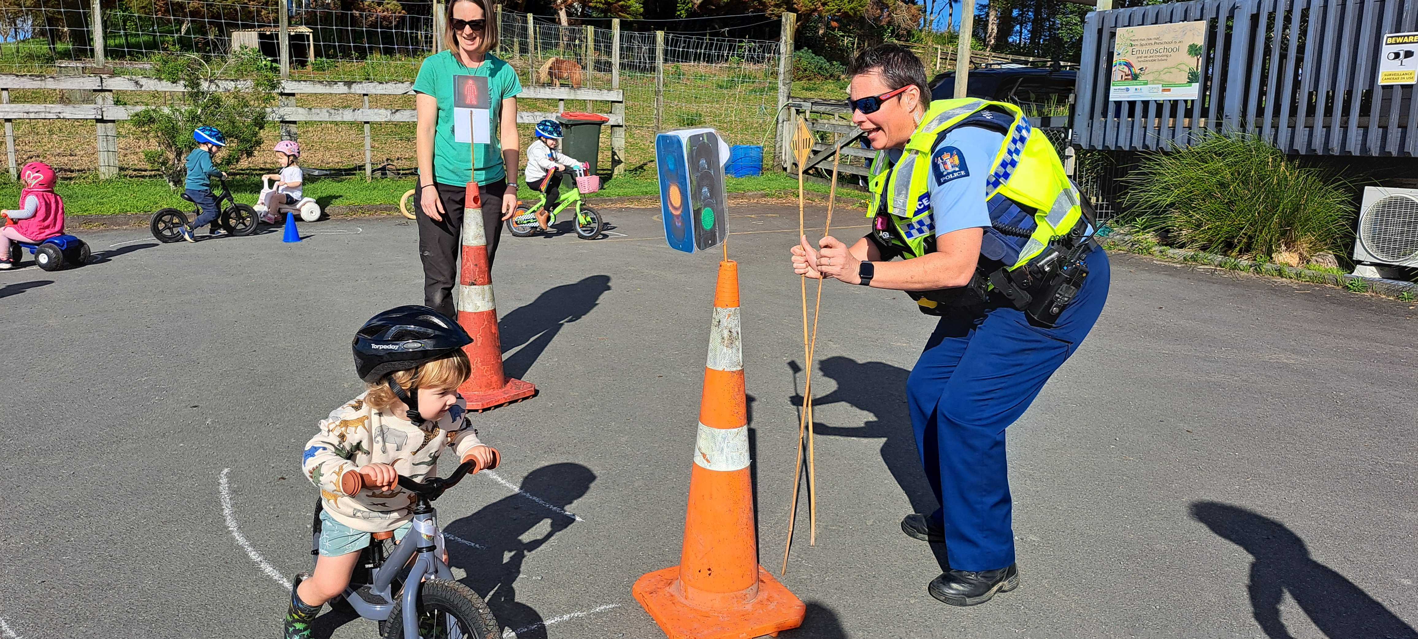 Kaden Johnson rides his bike, encouraged by constable Alana Cameron. Photo / Brodie Stone