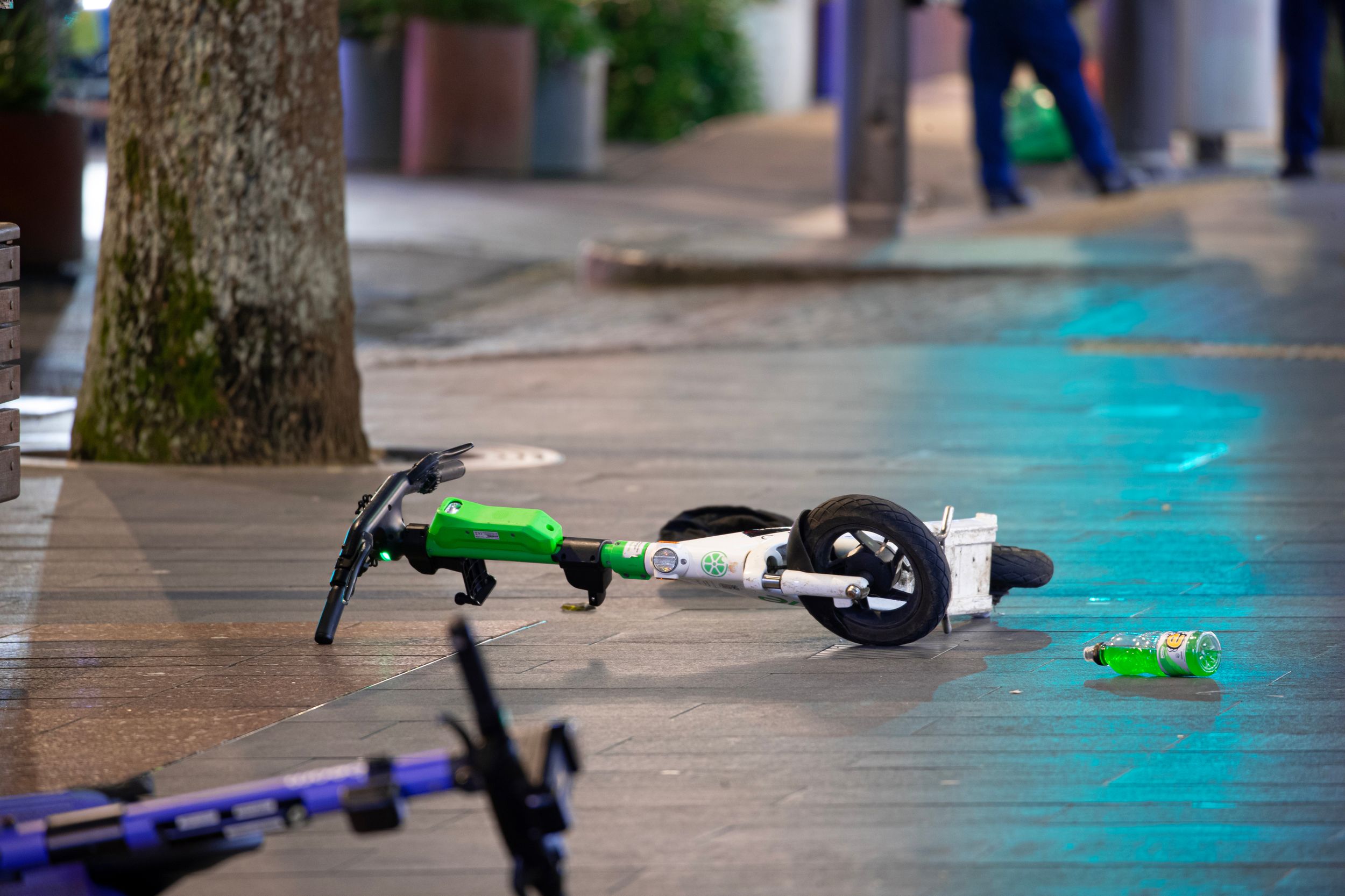 Electric scooters abandoned on lower Queen St following the shooting. Photo / Hayden Woodward