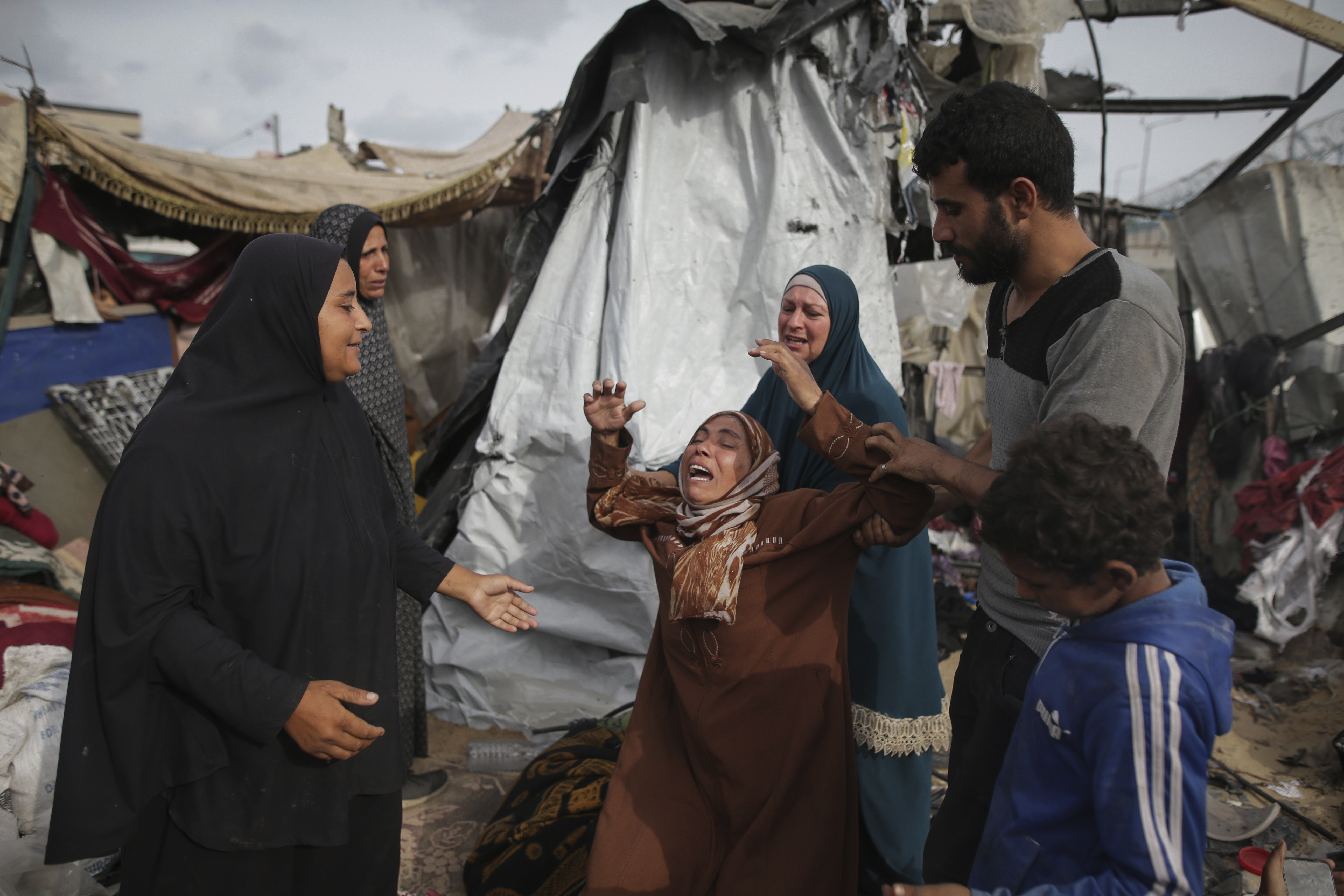 Displaced Palestinians inspect their tents destroyed by Israel's bombardment. Photo / AP