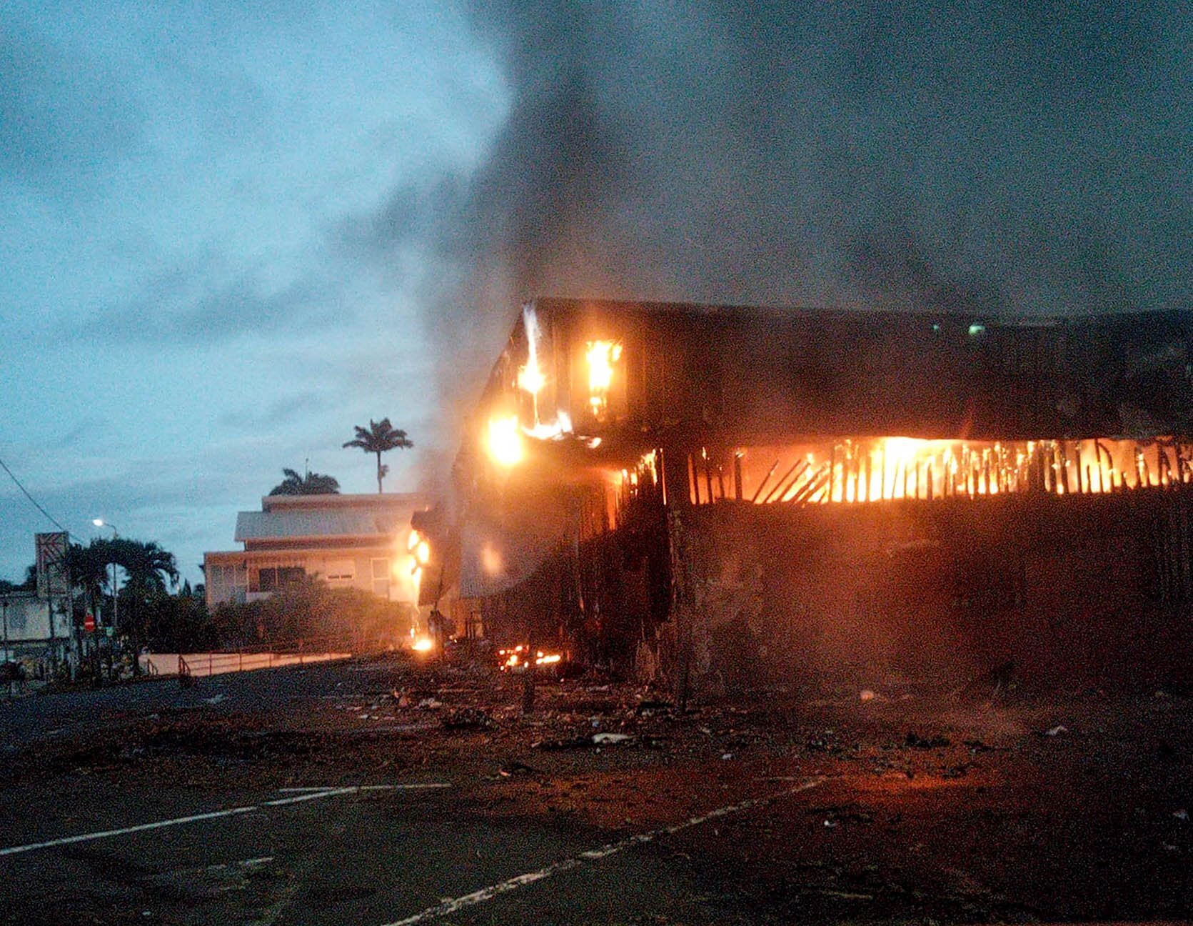 A building burns in Noumea on May 15 during rioting over a proposed change to New Caledonia's constitution.