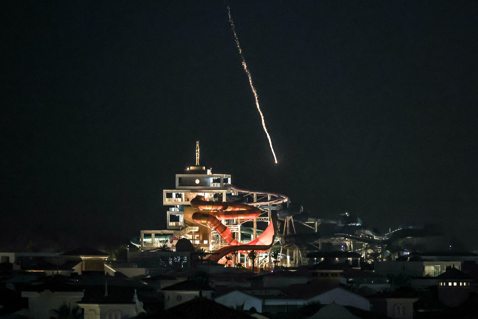 An intercepted projectile falls into the sea near Dubai's Palm Jumeirah archipelago. Photo / AFP