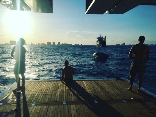Kane Taylor and crewmates take some downtime to fish off the back of their superyacht. Photo / Supplied