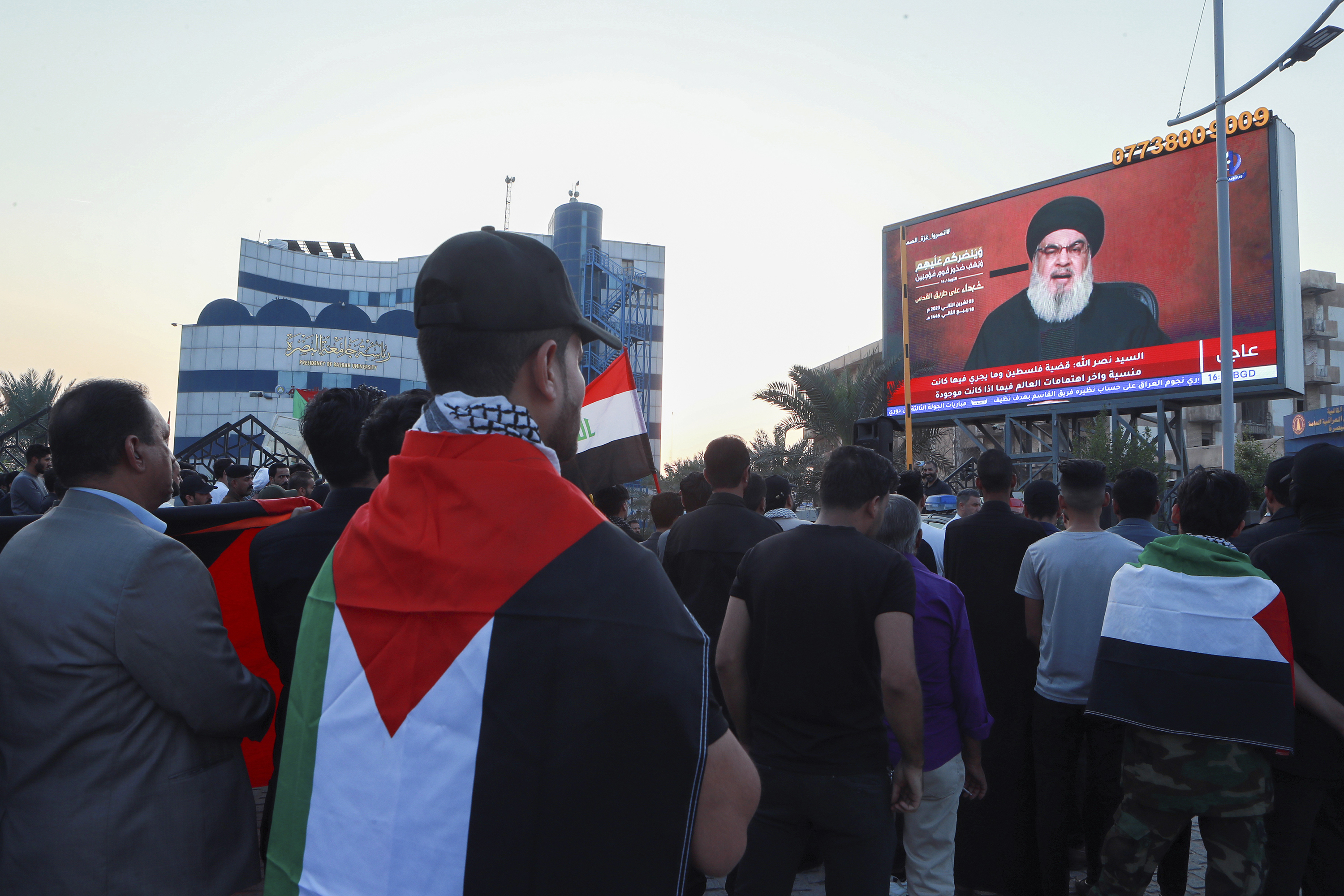 Iraqi demonstrators watch a speech from Lebanon's militant Hezbollah leader Sayyed Hassan Nasrallah. Photo / AP