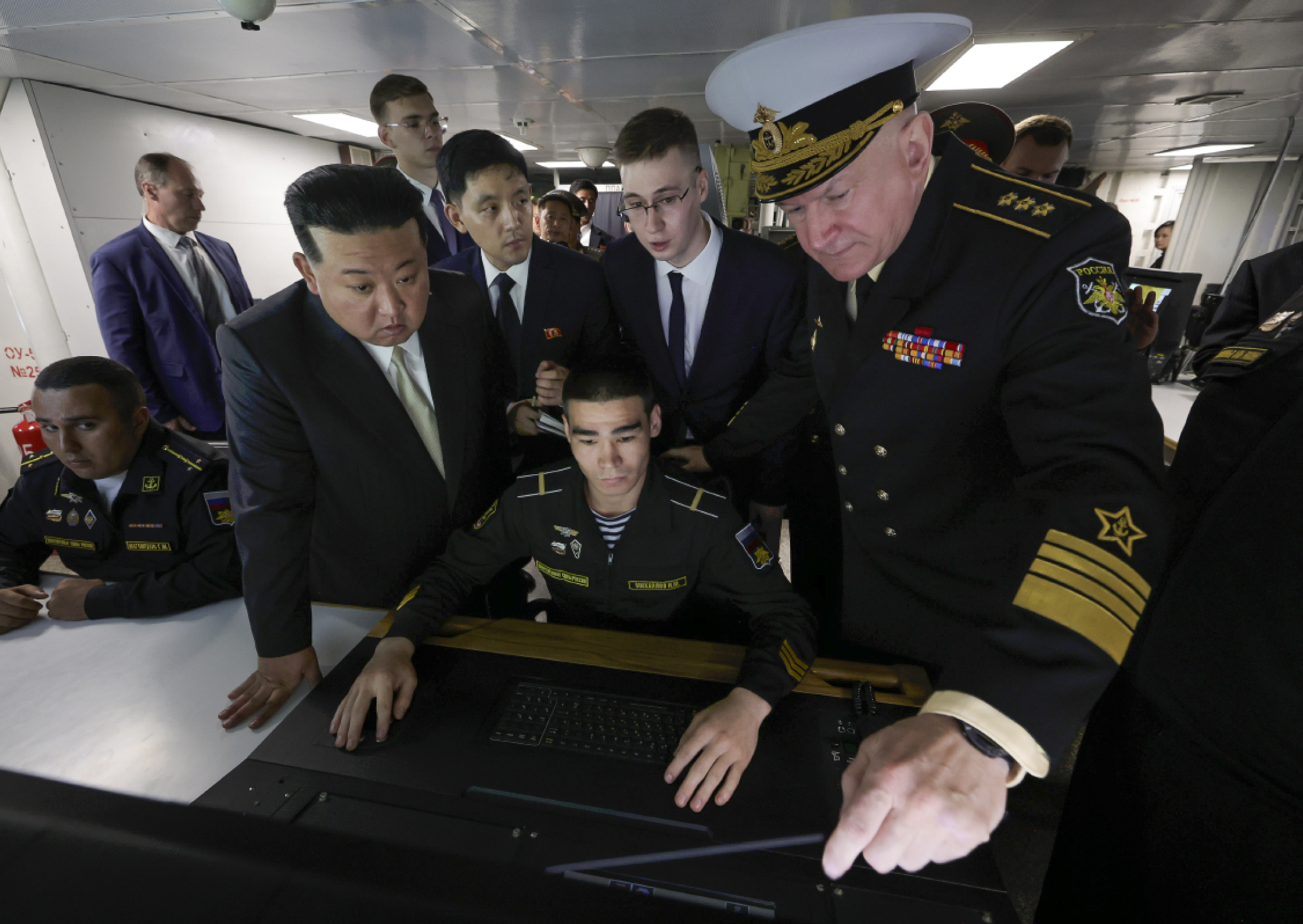 North Korea's leader Kim Jong Un, foreground left, listens to explanations by Admiral Nikolai Yevmenov, Commander-in-Chief of the Russian Navy, right, while visiting the Admiral Shaposhnikov frigate of the Russian navy in the port of Vladivostok. Photo / AP