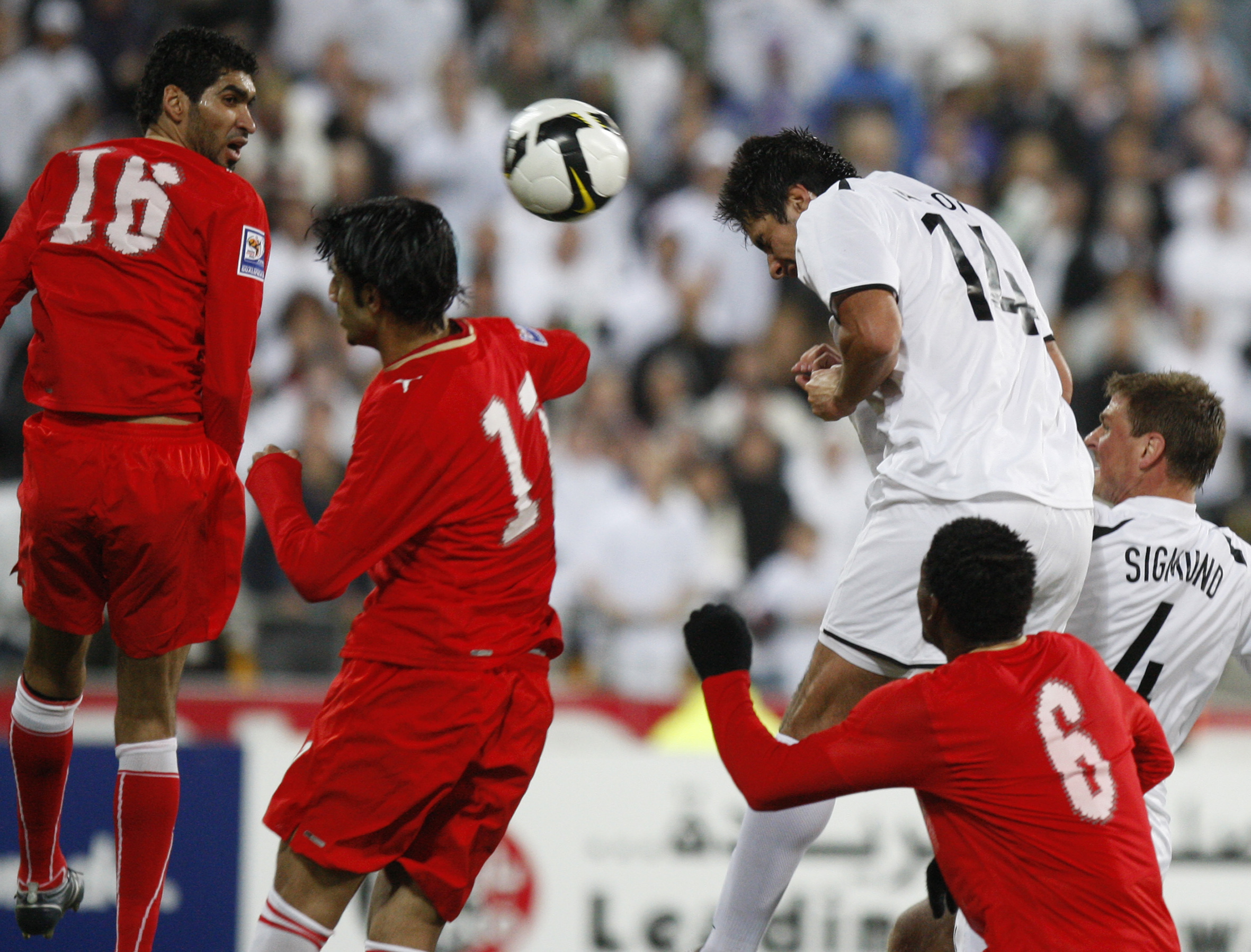 All Whites striker Rory Fallon gets above the Bahrain defenders to head the ball into the goal . Photo / Mark Mitchell