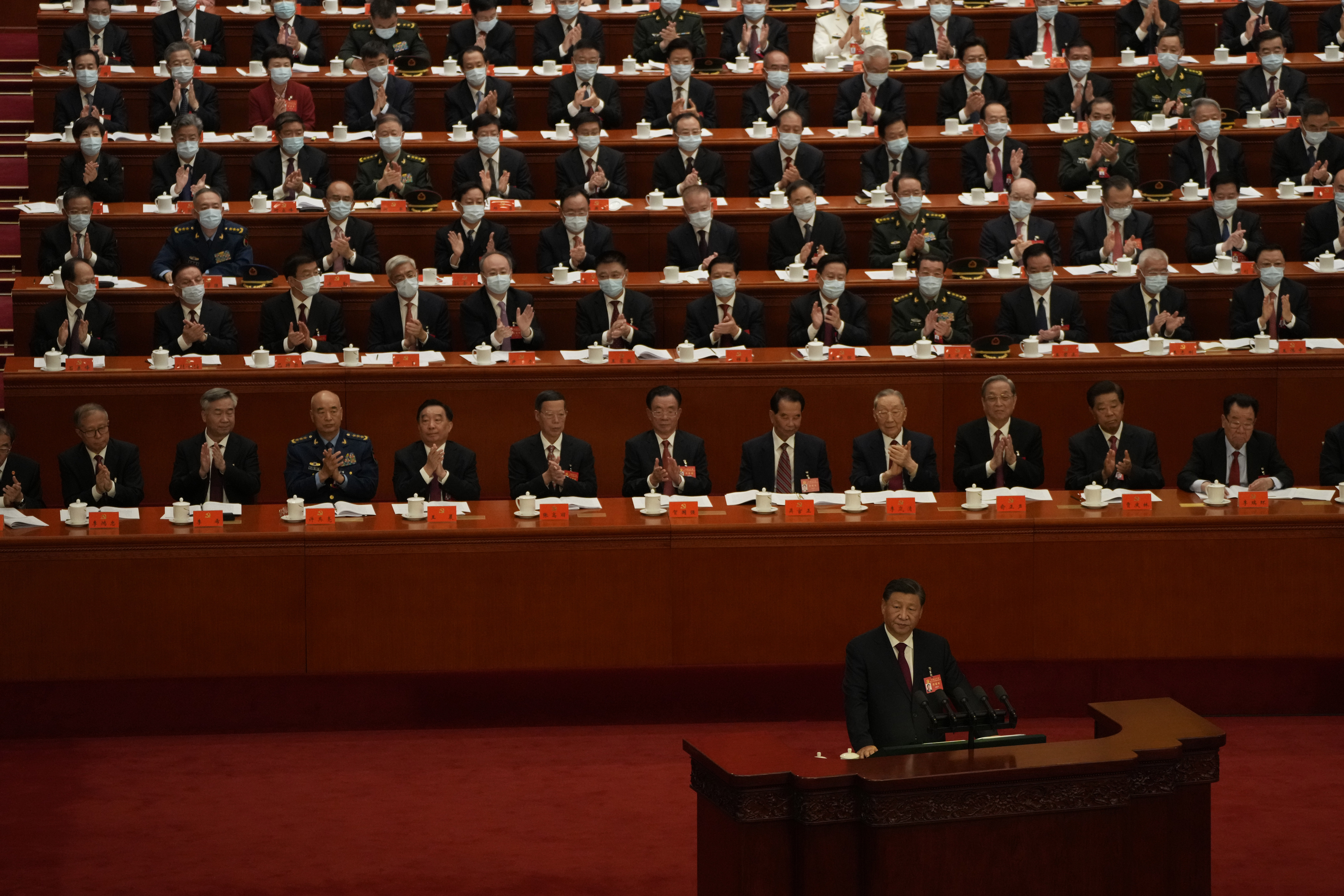 Delegates applaud as Chinese President Xi Jinping speaks. Photo / Mark Schiefelbein, AP