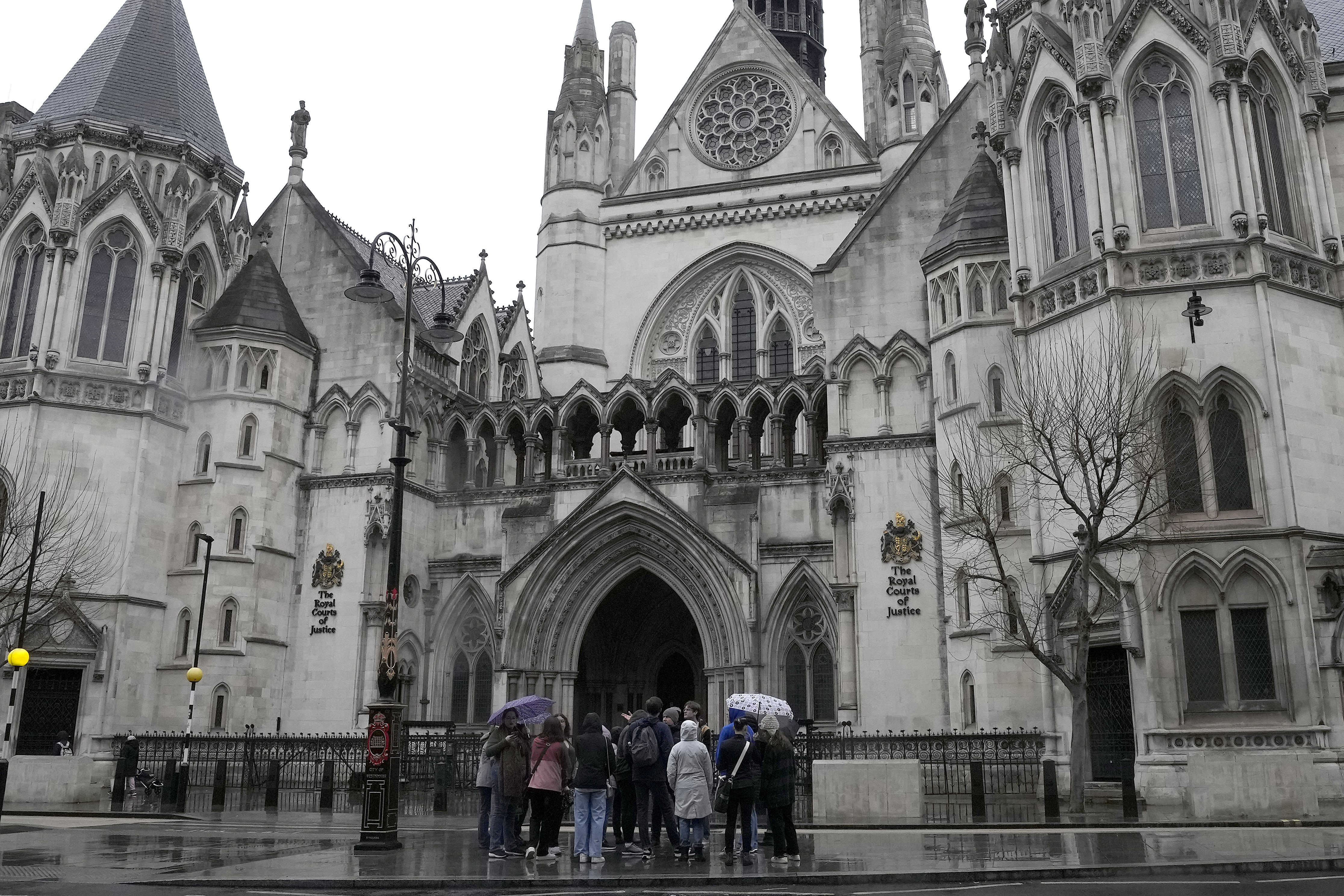 People stand outside the Royal Court of Justice in London on Friday.  Prince Harry, the Duke of Sussex, is suing Associated Newspapers Limited (ANL) over an article regarding security arrangements for himself and his family when they are in the UK. Photo / AP