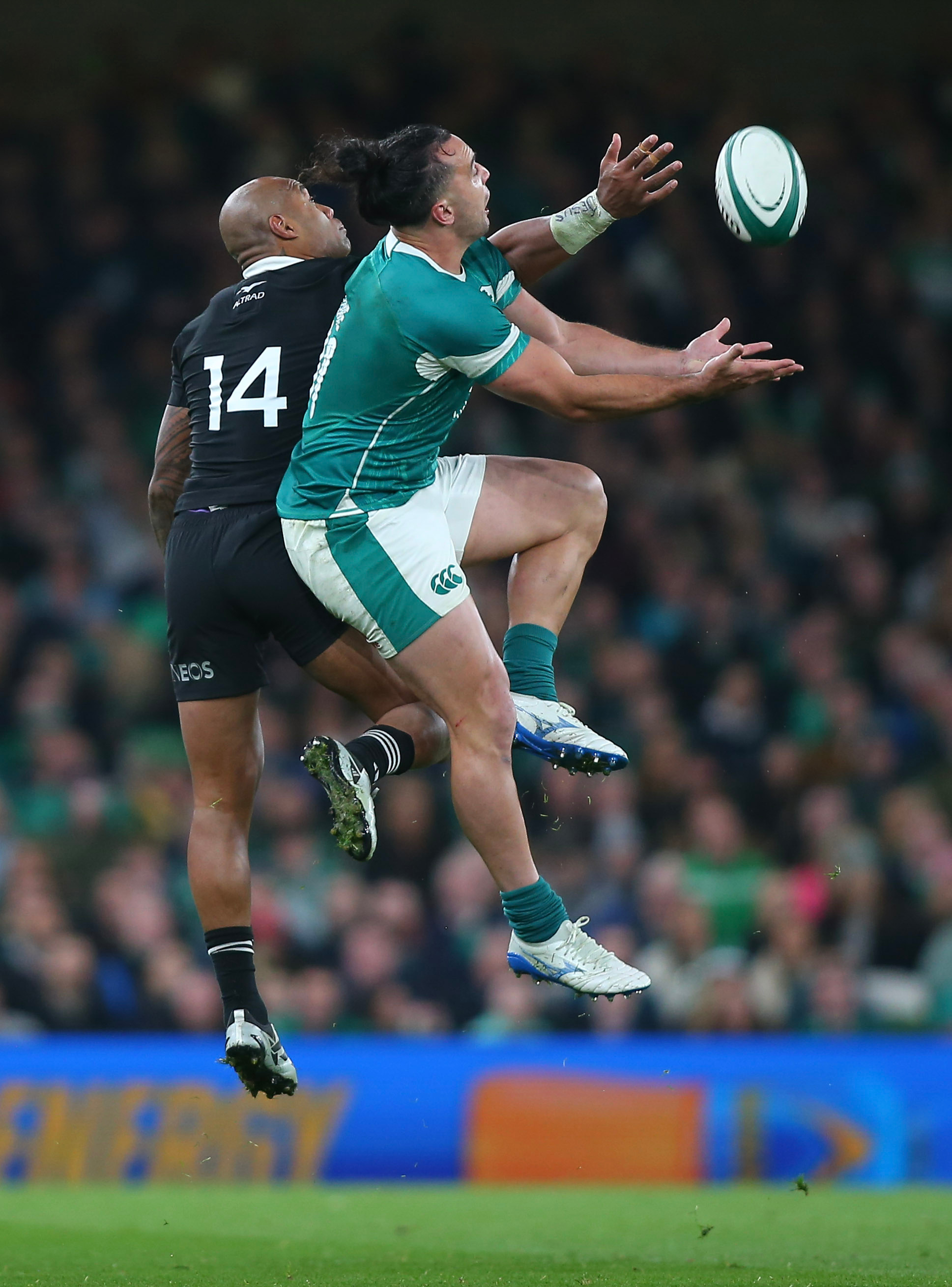 New Zealand's Mark Tele'a and Ireland's James Lowe contest a high kick. Photo / Photosport