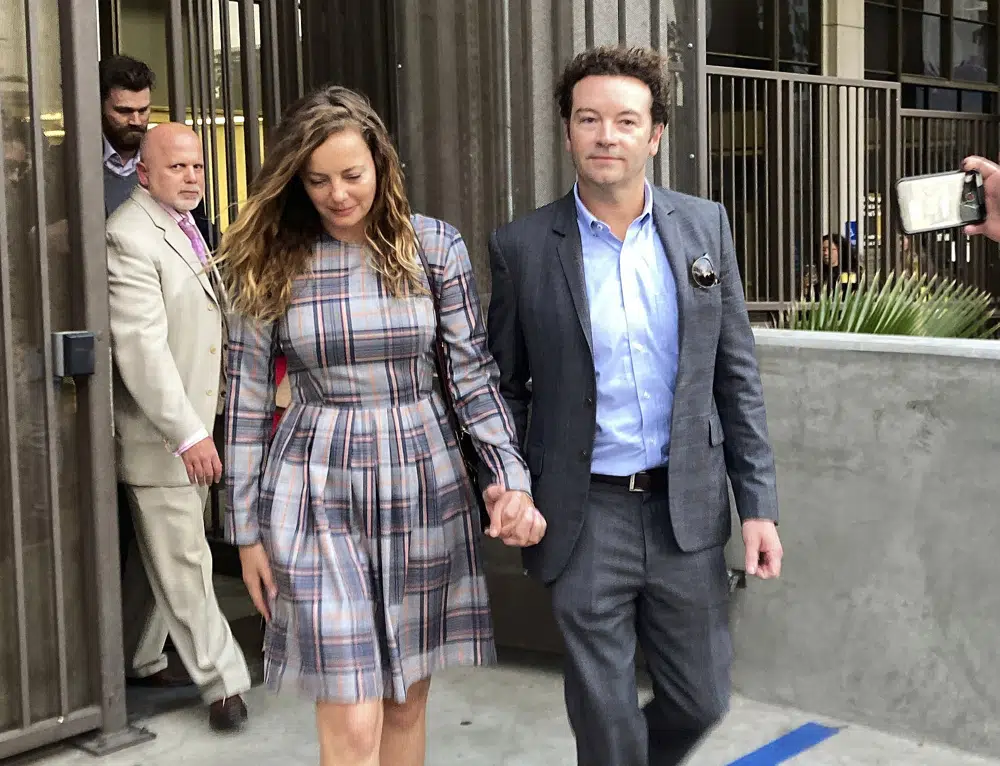Actor Danny Masterson leaving court with his wife Bijou Phillips last year, after a judge declared a mistrial. Masterson's retrial has resulted in a 30 year to life imprisonment. Photo / AP