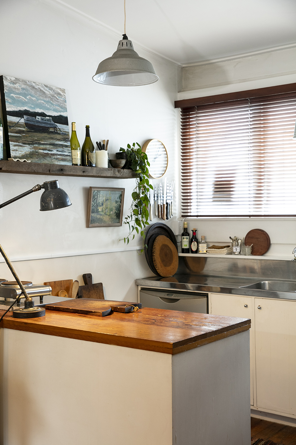 Cox’s Bay by Max Thomson, 2020, hangs on a shelf in the kitchen. Photo / Babiche Martens