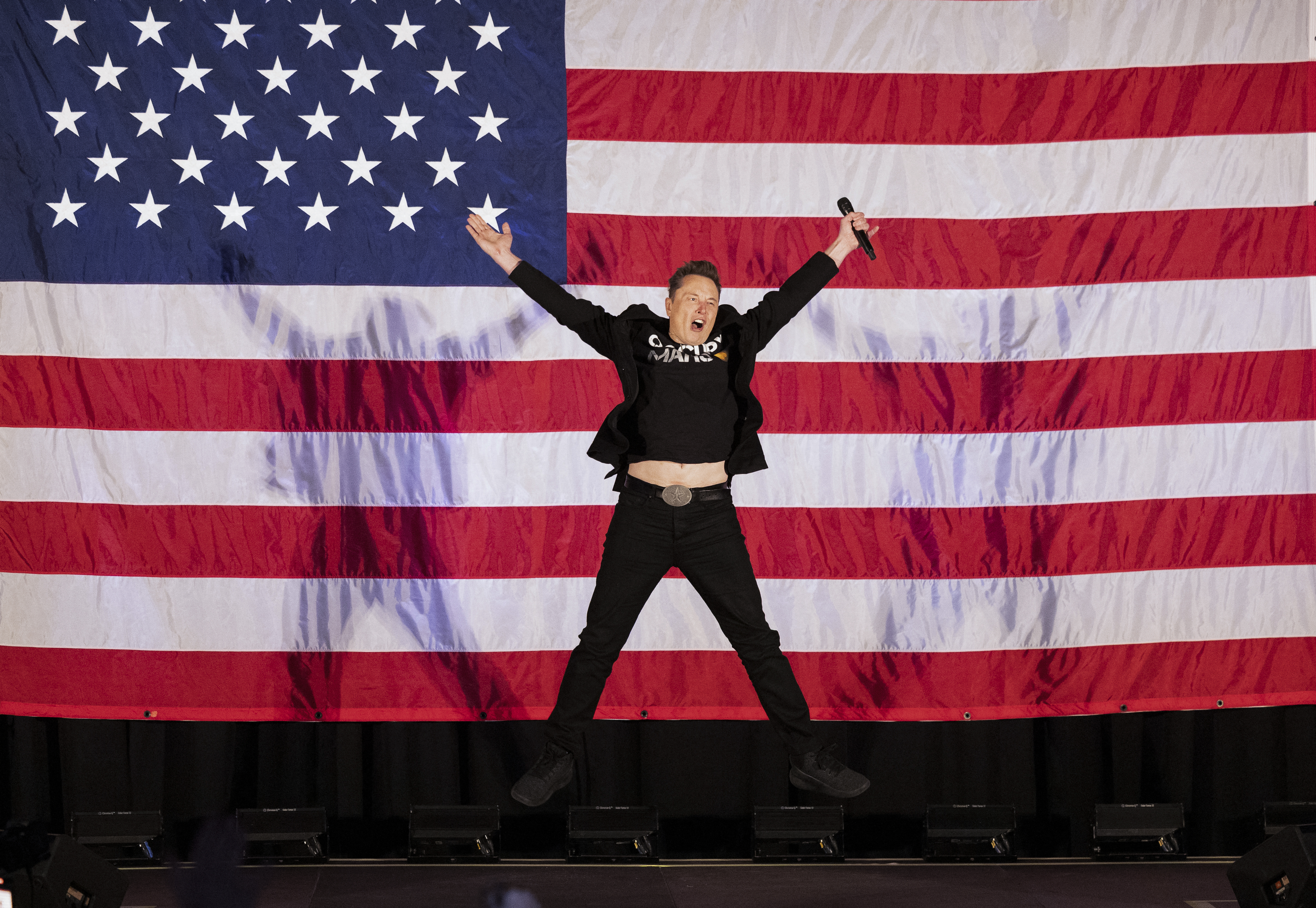Tesla and SpaceX CEO Elon Musk jumps on stage as he arrives to speak at a town hall event hosted by America PAC in support of former US President and Republican presidential candidate Donald Trump. Photo / AFP