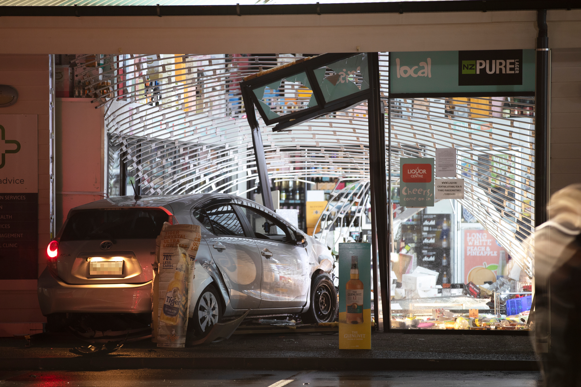 A ram raid burglary at the Liquor Centre in Greenhithe, Auckland in May. Photo / Hayden Woodward
