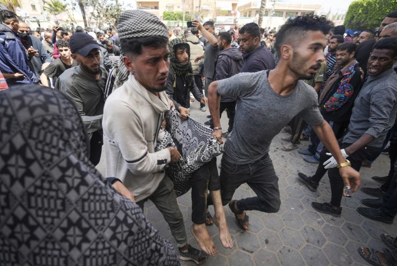 Palestinians evacuate a victim of an Israeli airstrike near the Al Aqsa hospital in Deir al Balah, Gaza Strip. Photo / AP